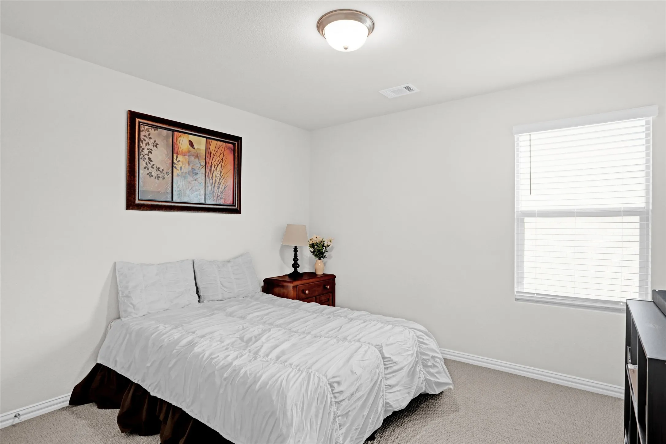 Bedroom featuring light colored carpet and baseboards