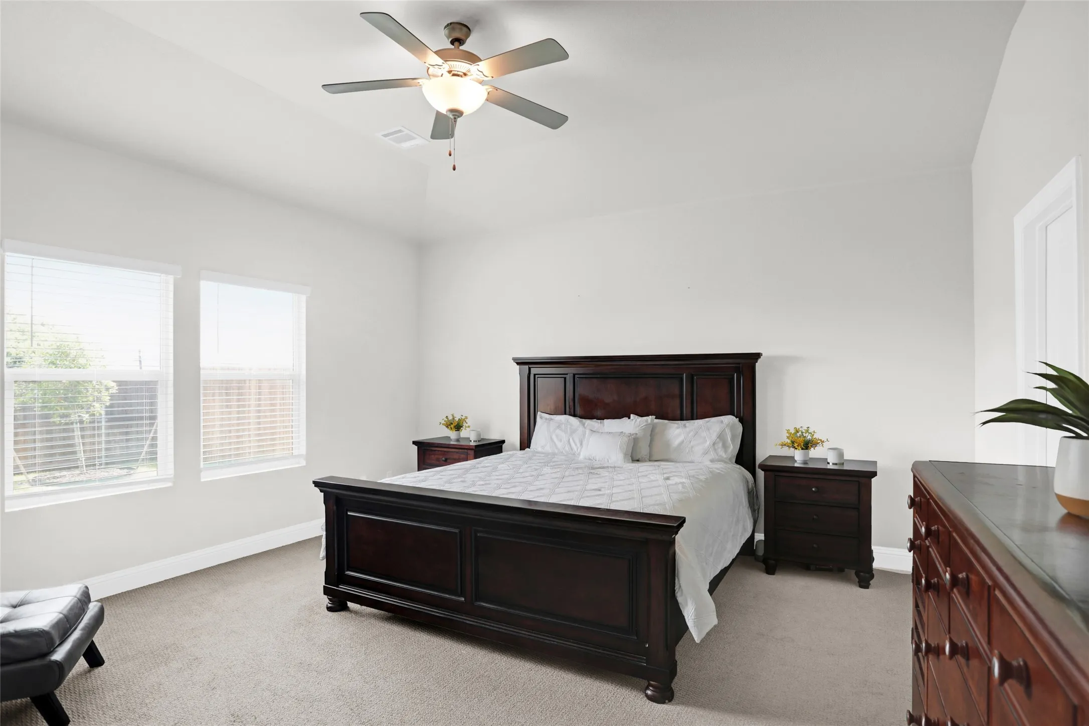 Bedroom featuring light carpet and a ceiling fan