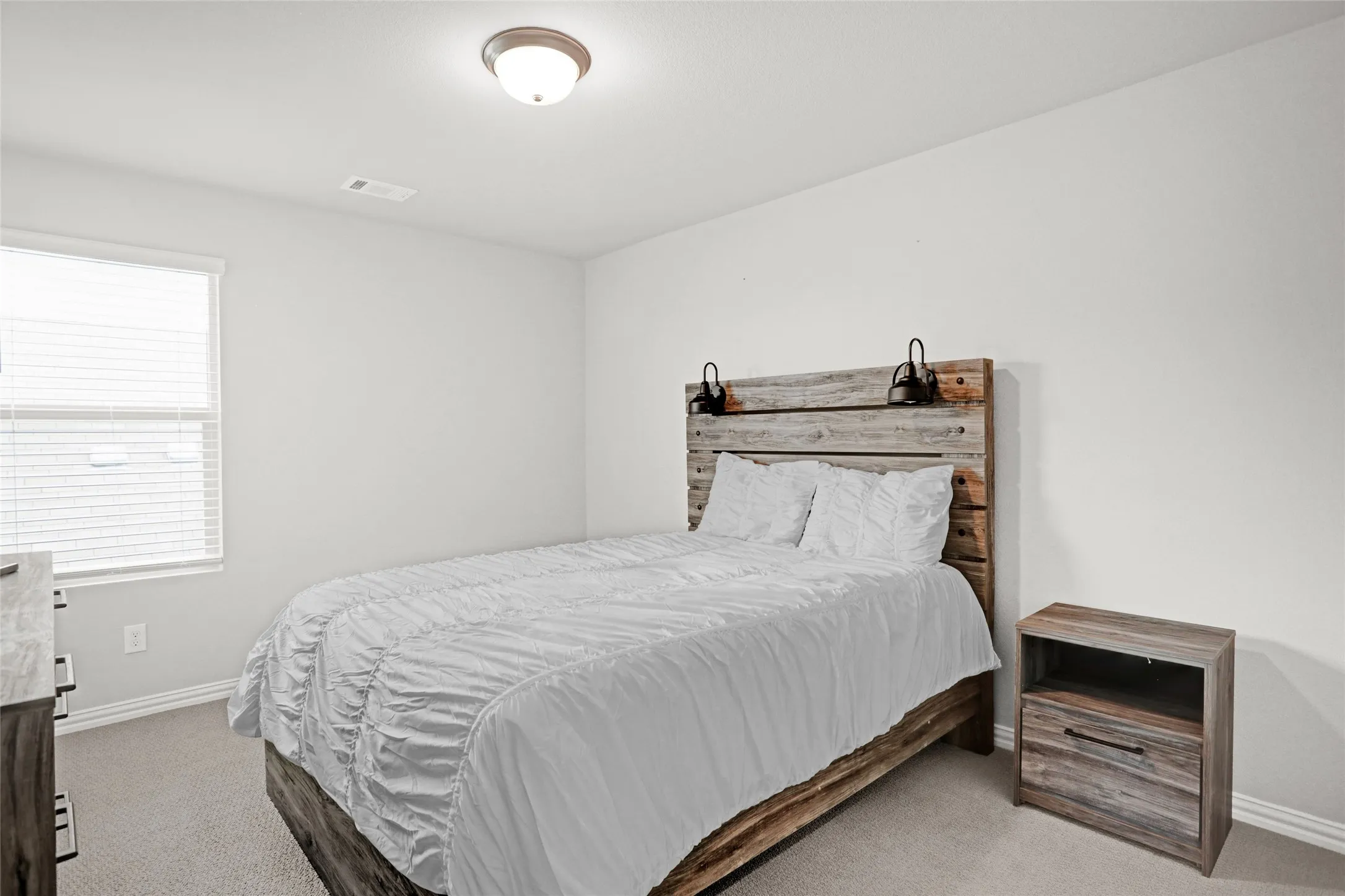 Bedroom with carpet flooring and baseboards