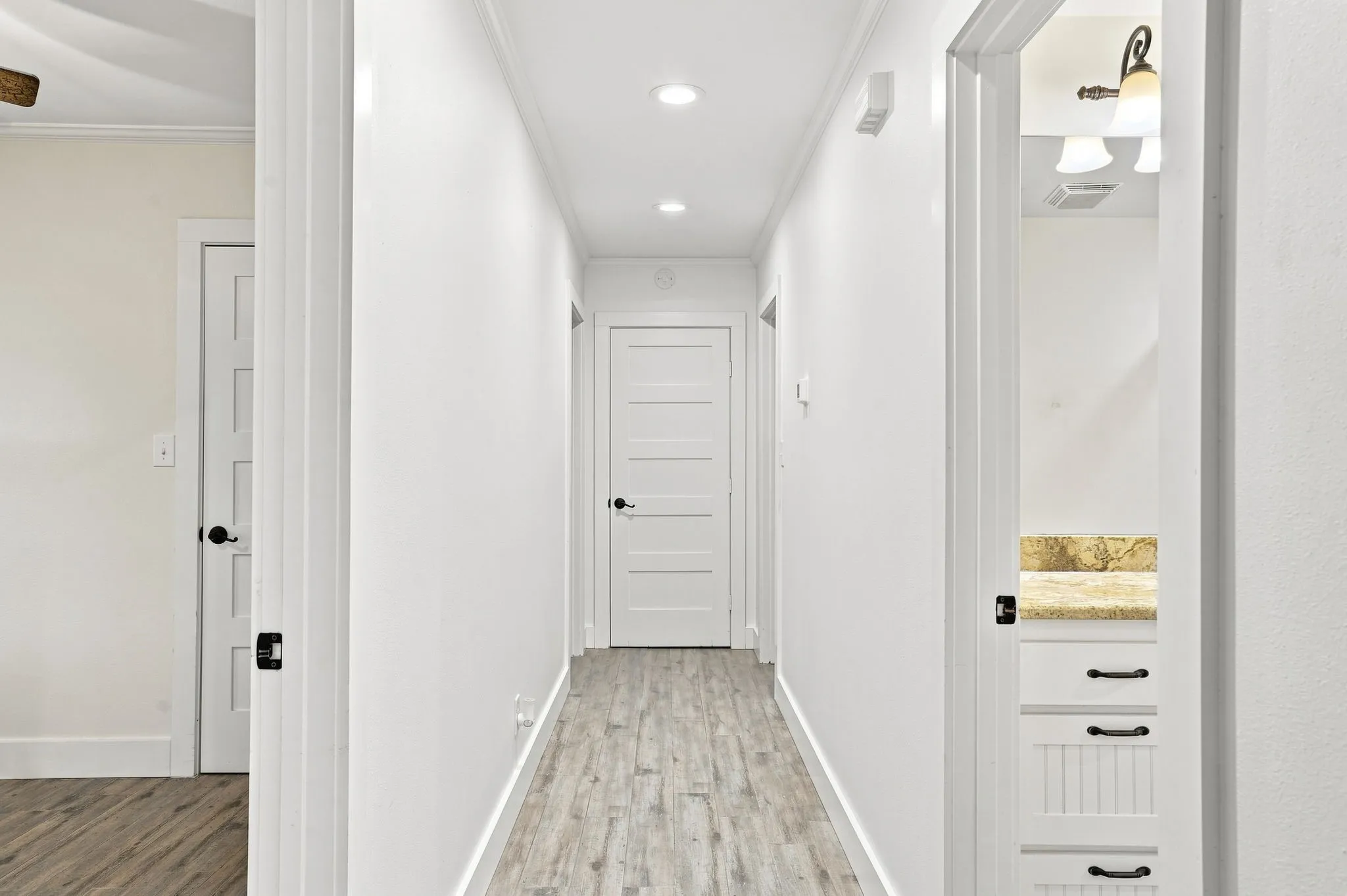 Hallway featuring wood-finish flooring and recessed lighting