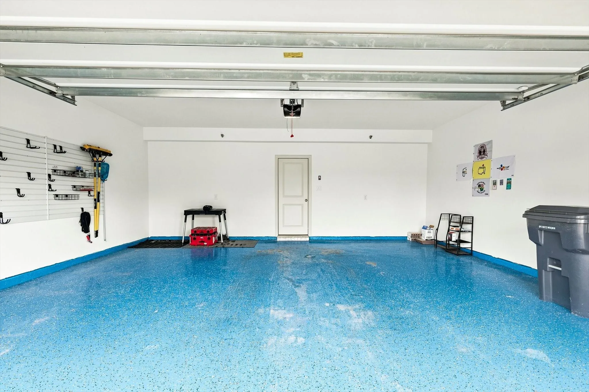 Even the garage gets an upgrade. A spacious two-car garage with wall-mounted organization and a finished floor adds both function and a clean, polished feel.