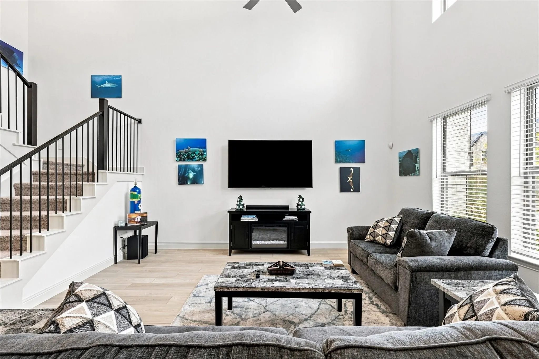 Volume, light, and style come together in this spectacular living space, where towering ceilings create an undeniable sense of grandeur.