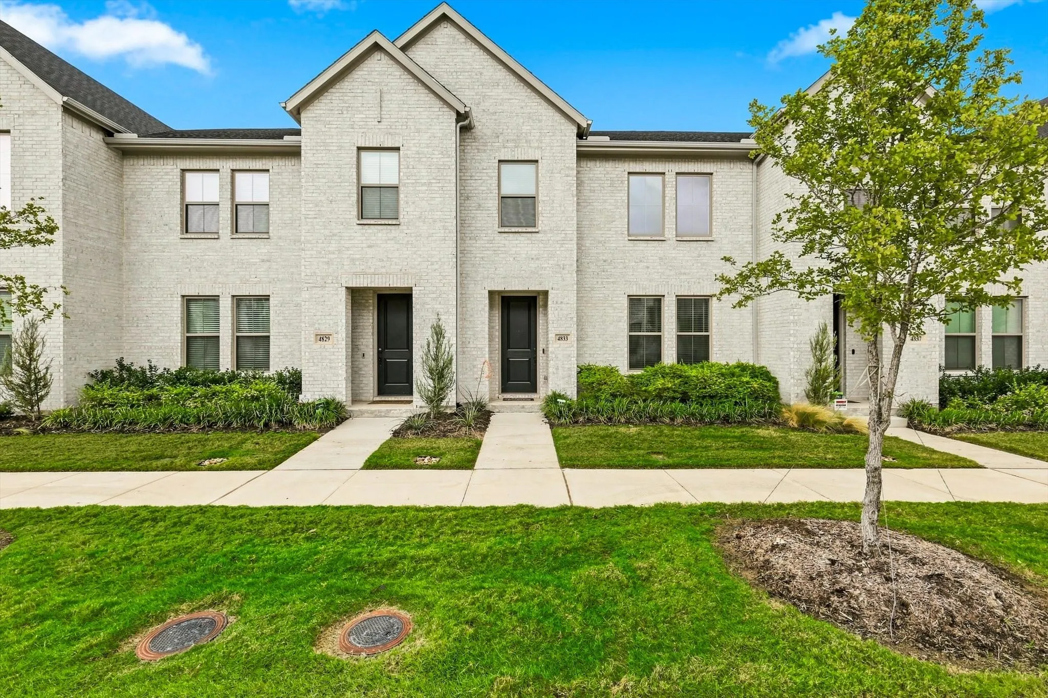 Modern curb appeal at its finest. Crisp white brick, bold black accents, and striking rooflines give 4833 Lunker Street an unforgettable first impression.
