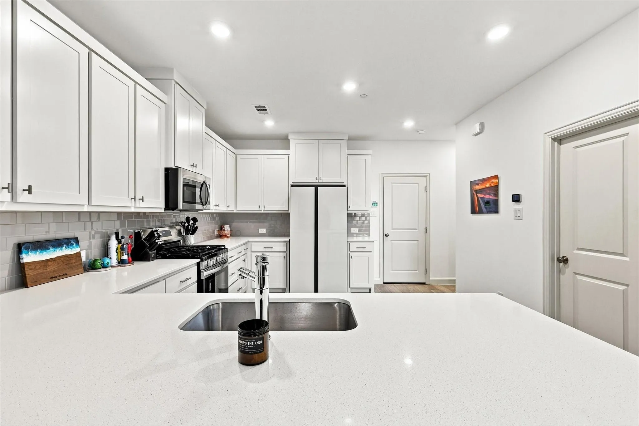 A kitchen that delivers on both style and function, with generous counter space, abundant cabinetry, stainless appliances, and an oversized island ready for entertaining.