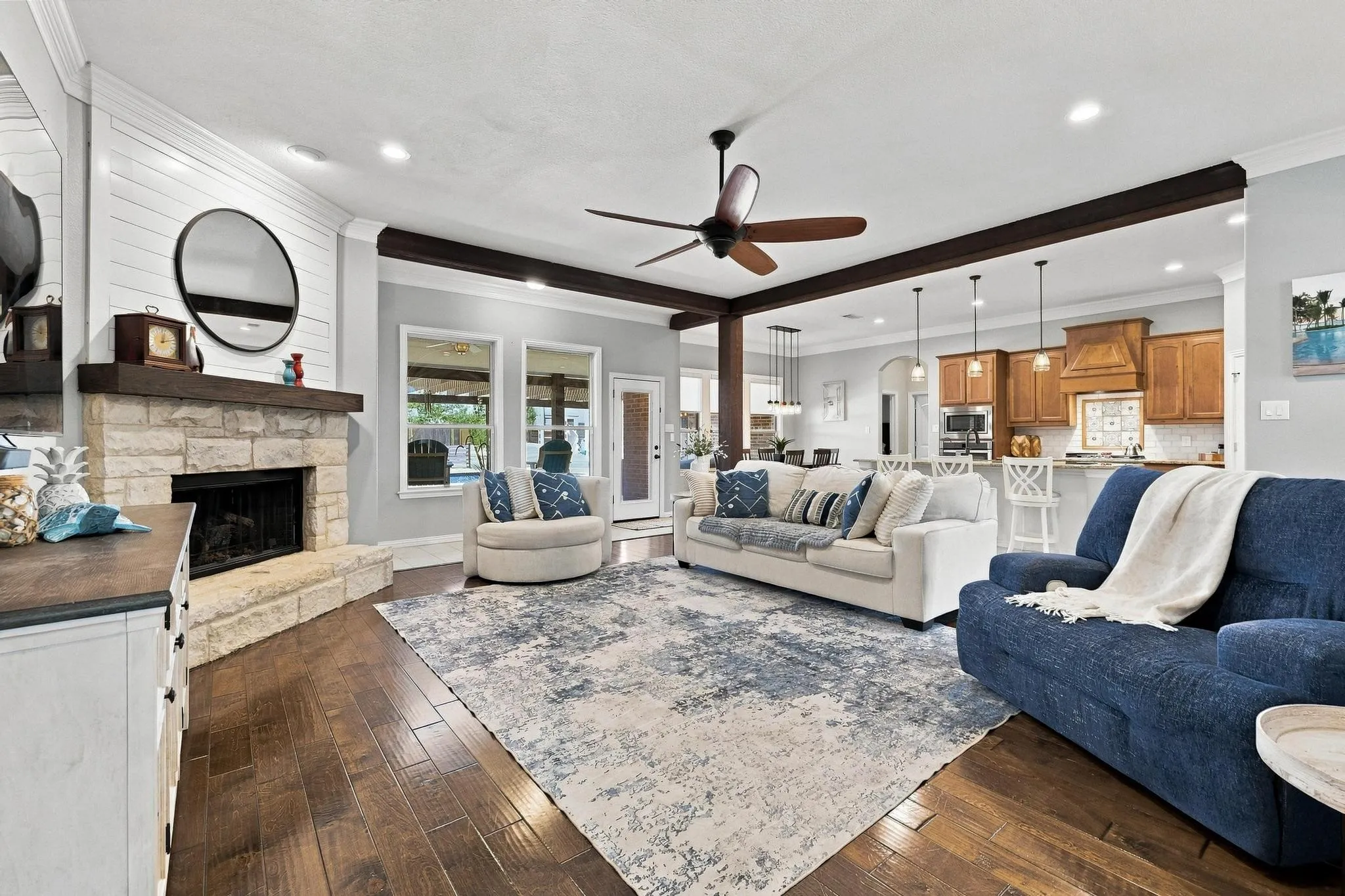 Open Concept Living. Stone Gas Fireplace, Overlooks Backyard. Neutral Palette, Warm Wood Trim.