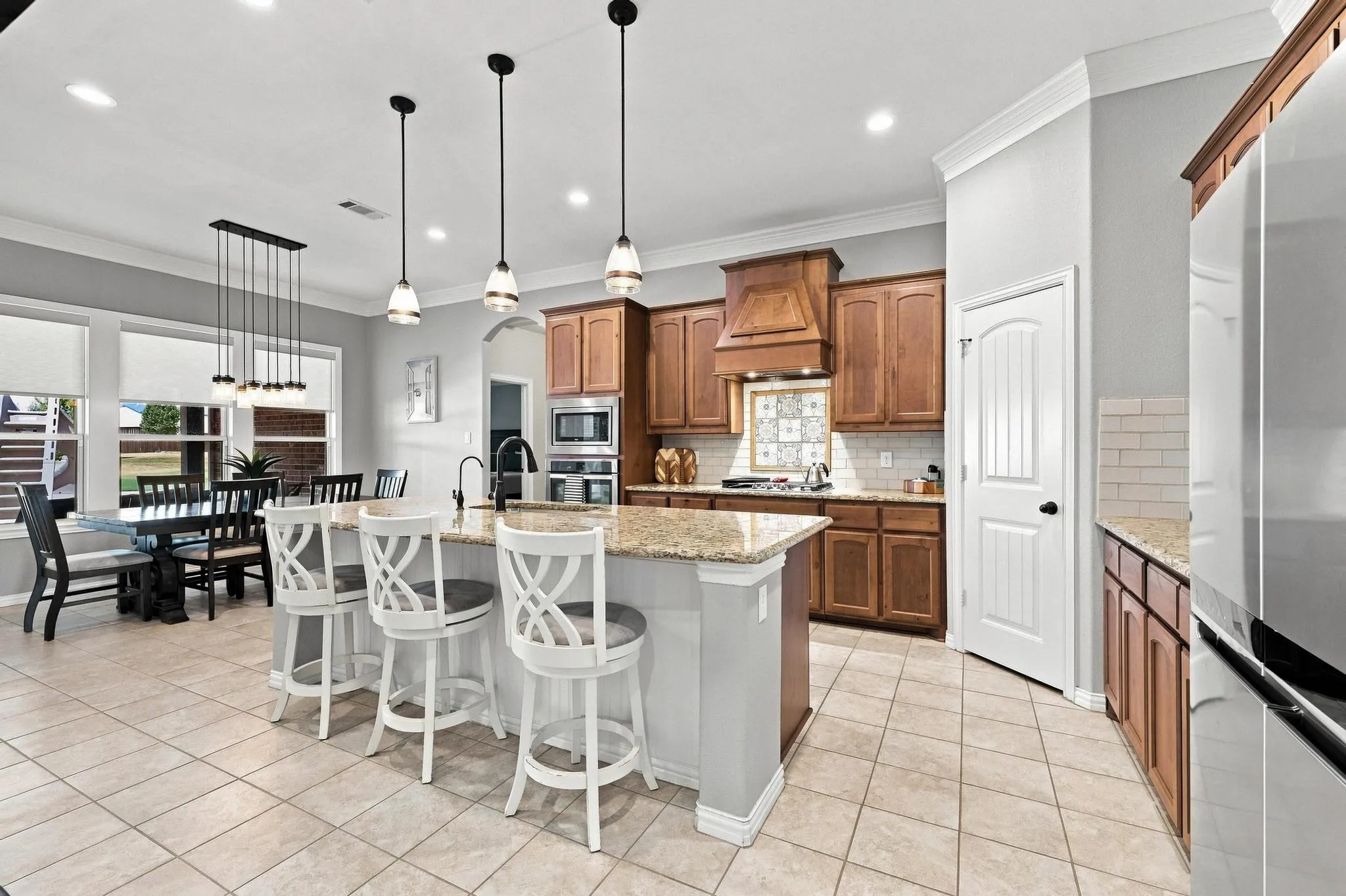 Kirchen made for a Cook and Entertainment! Gas Stovetop with Griddle, Huge Island, Warm Wood Cabinetry, Walk In Pantry.
