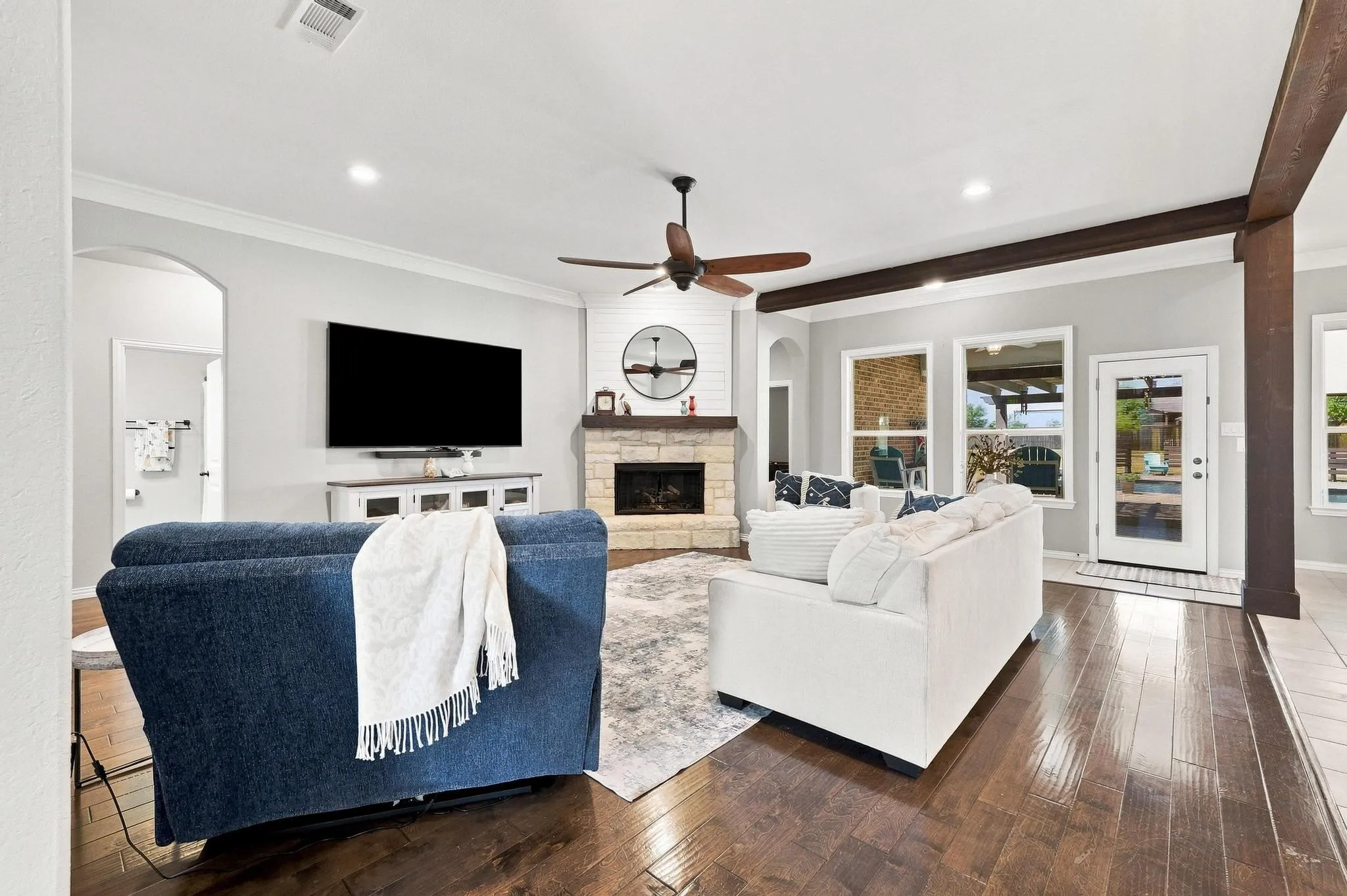 Open Concept Living. Stone Gas Fireplace, Overlooks Backyard. Neutral Palette, Warm Wood Trim.