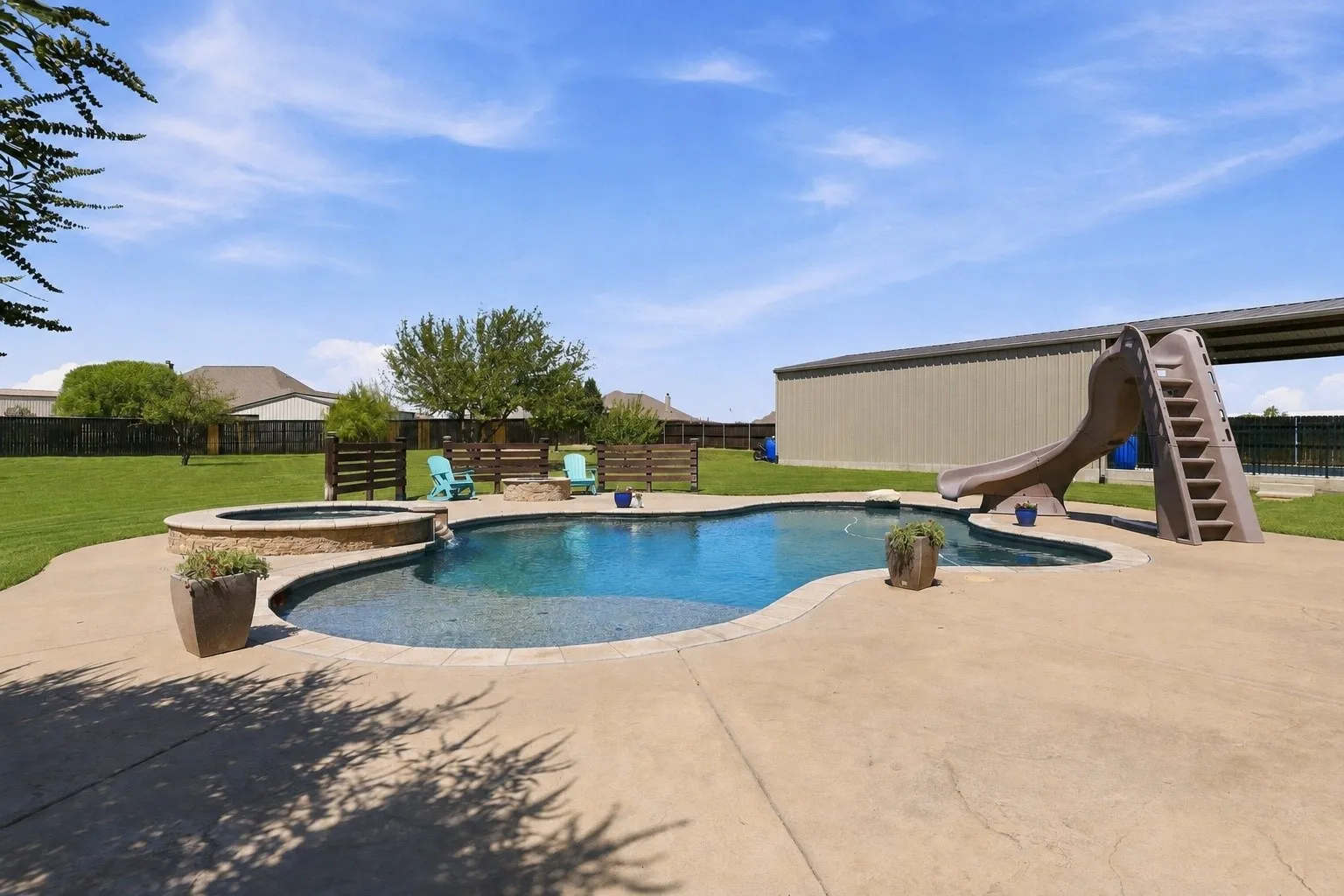 Grass is digitally enhanced. A Heated Gunite Saltwater Pool and Spa with all the Bells and Whistles! Lights, Sundeck, Slide and More!