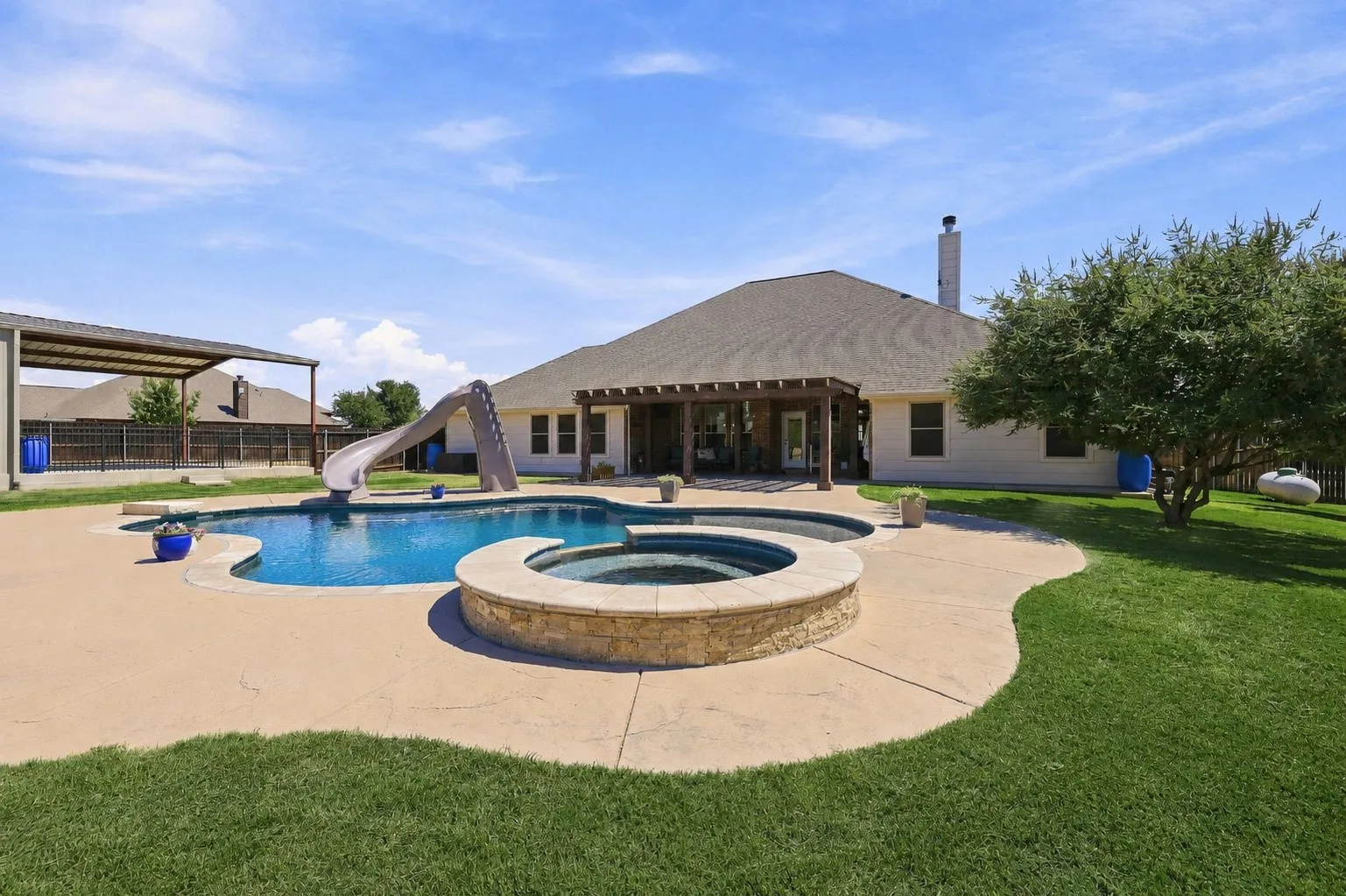 Grass is digitally enhanced. A Heated Gunite Saltwater Pool and Spa with all the Bells and Whistles! Lights, Sundeck, Slide and More!