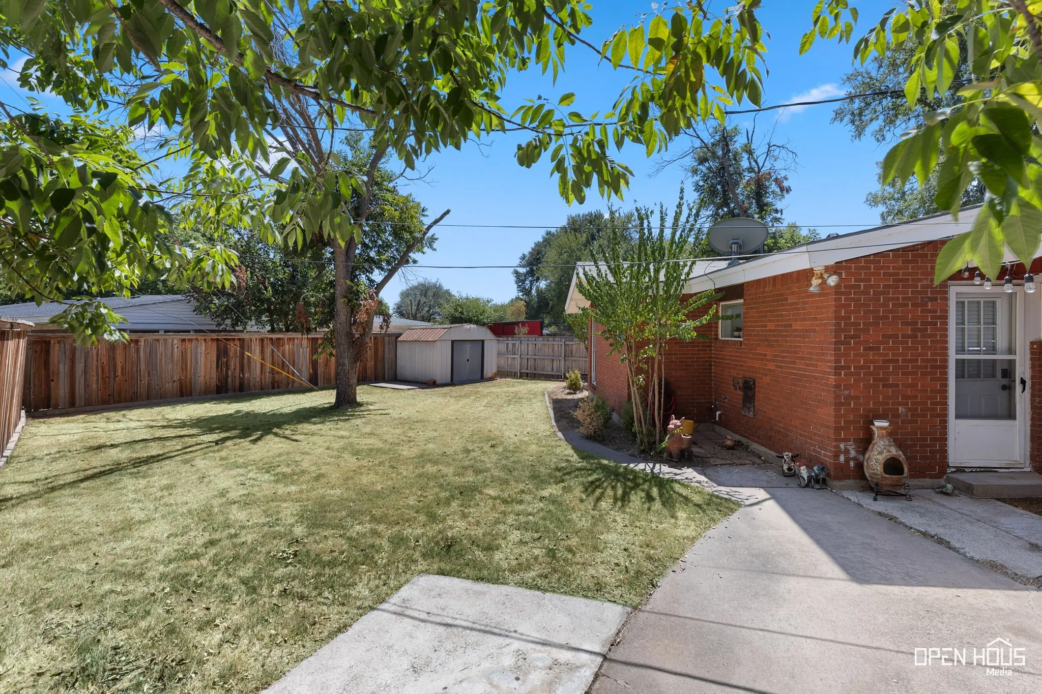 Expansive yard featuring a manicured lawn and mature trees