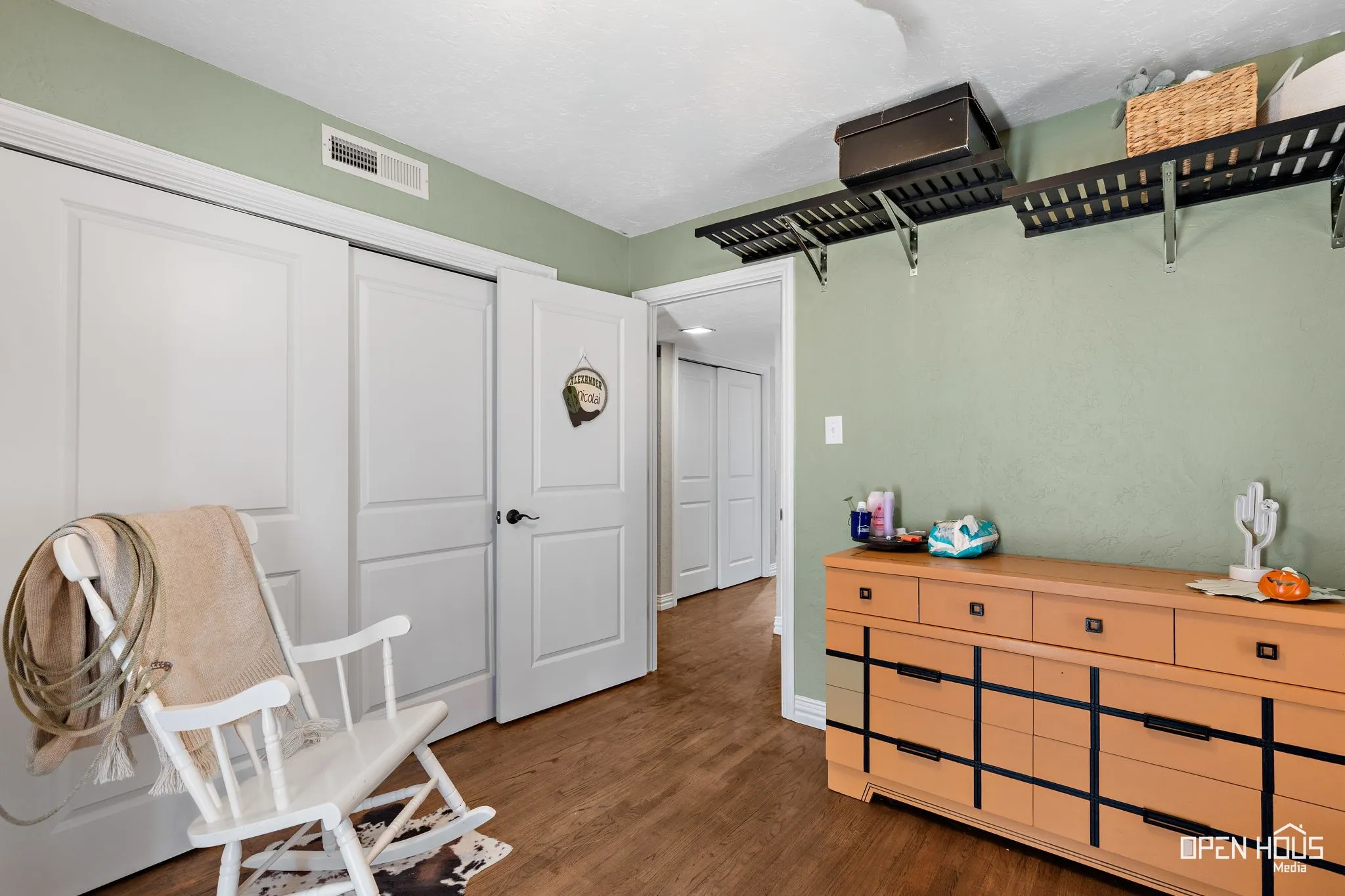 Wood-finish flooring with light green painted walls