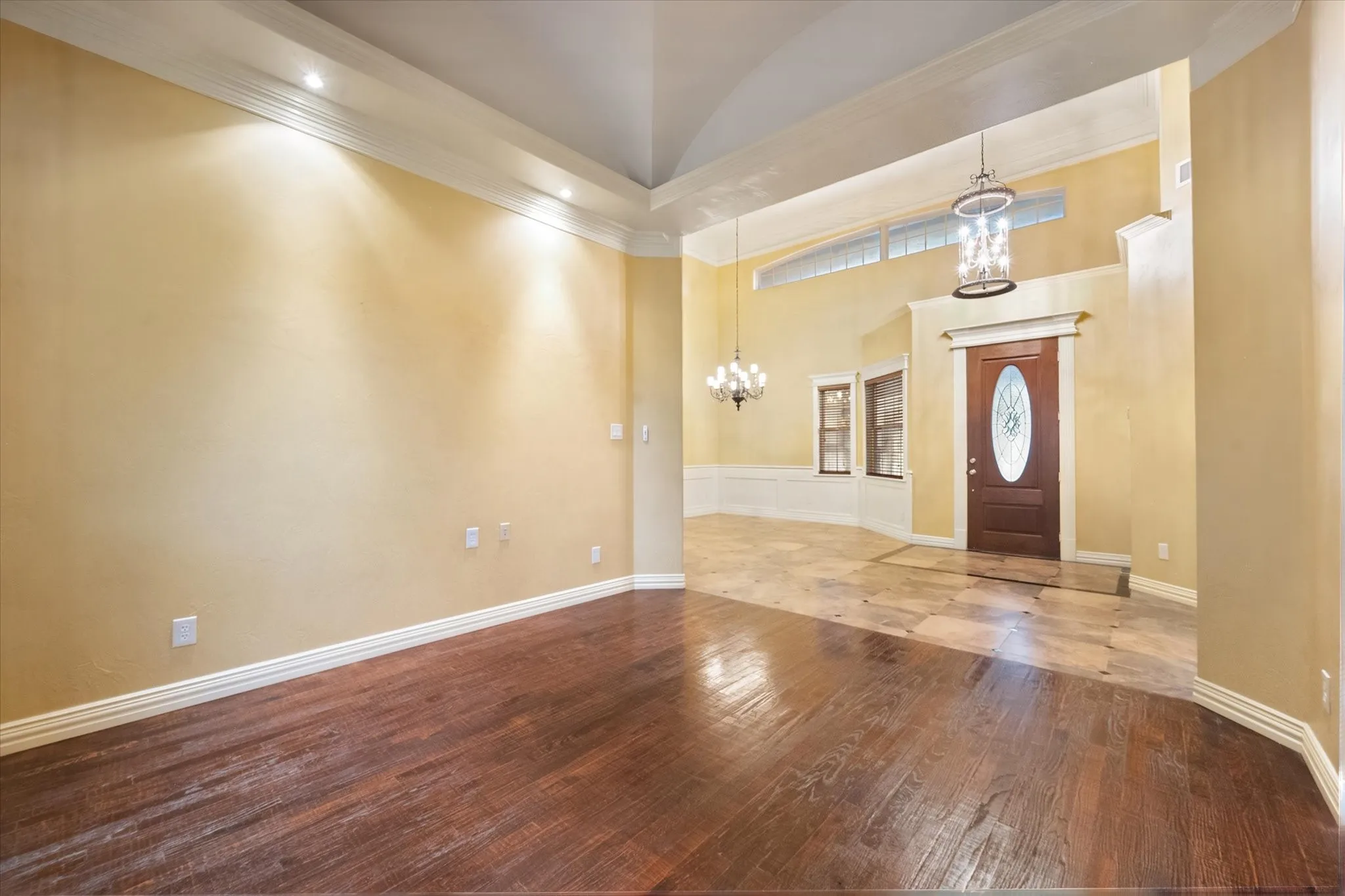 Living room with wood flooring, vaulted ceiling and gorgeous wood trim