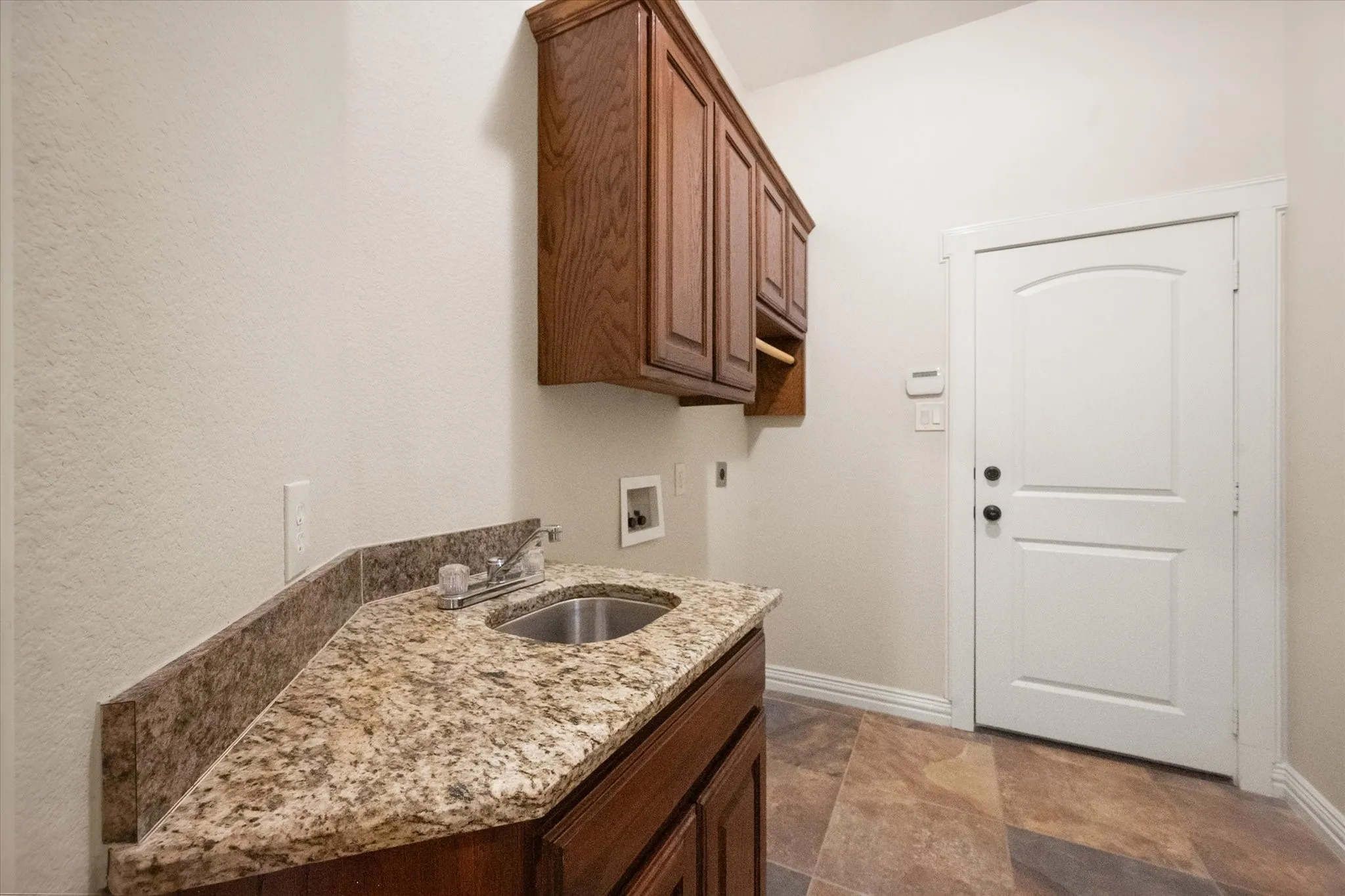 Cabinet storage and sink in laundry room