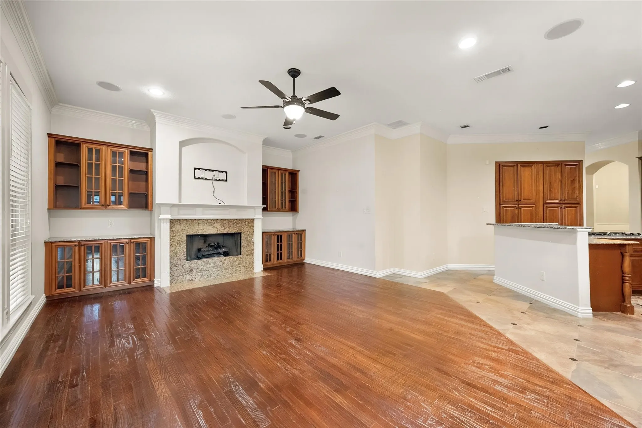 Large family room is open to kitchen and features beautiful built-ins