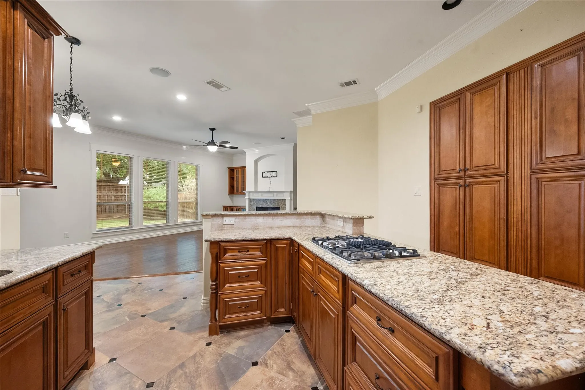 Kitchen features custom wood cabinets and granite countertops