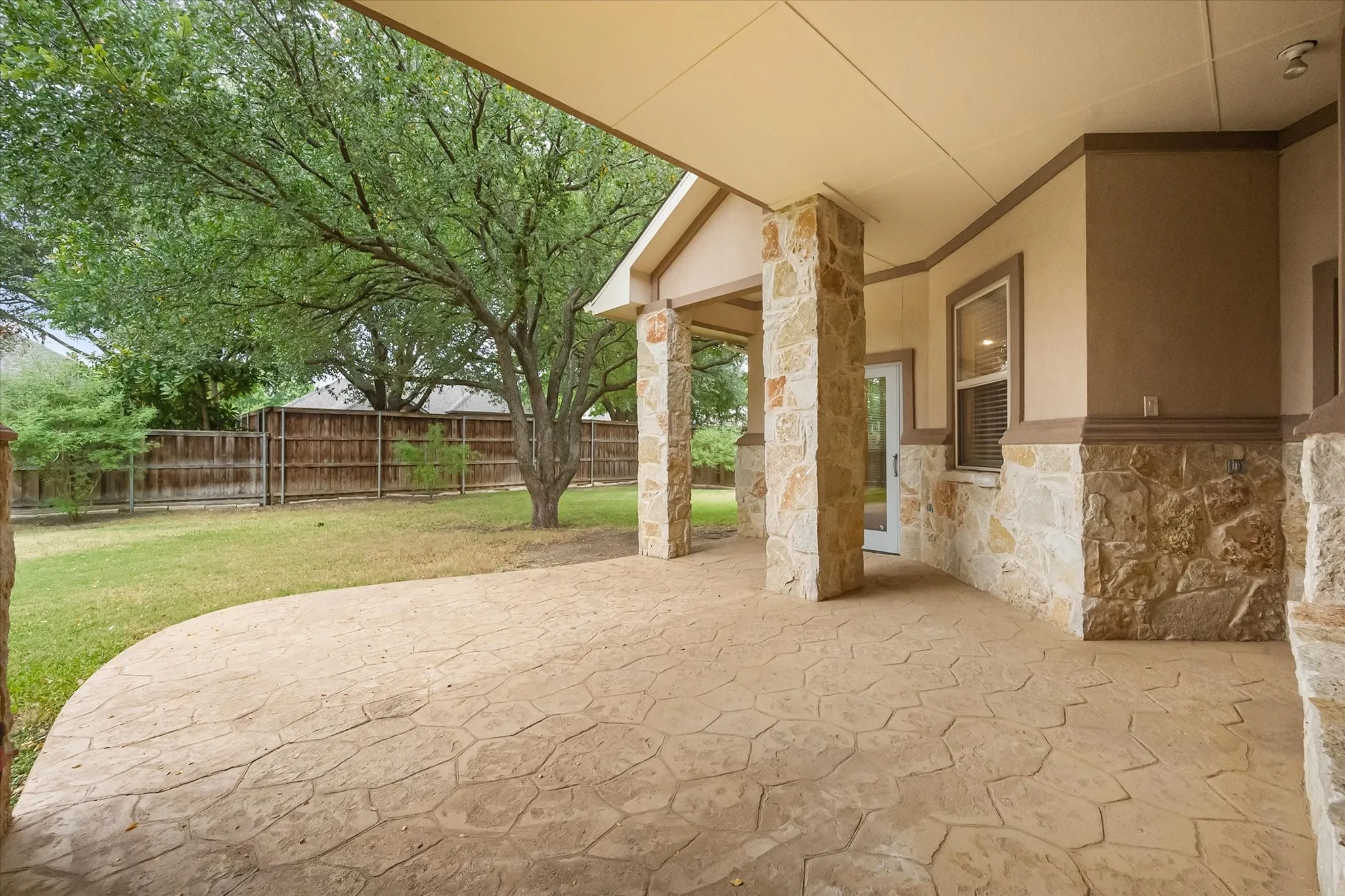 Enjoy the outdoors on this covered patio and large backyard