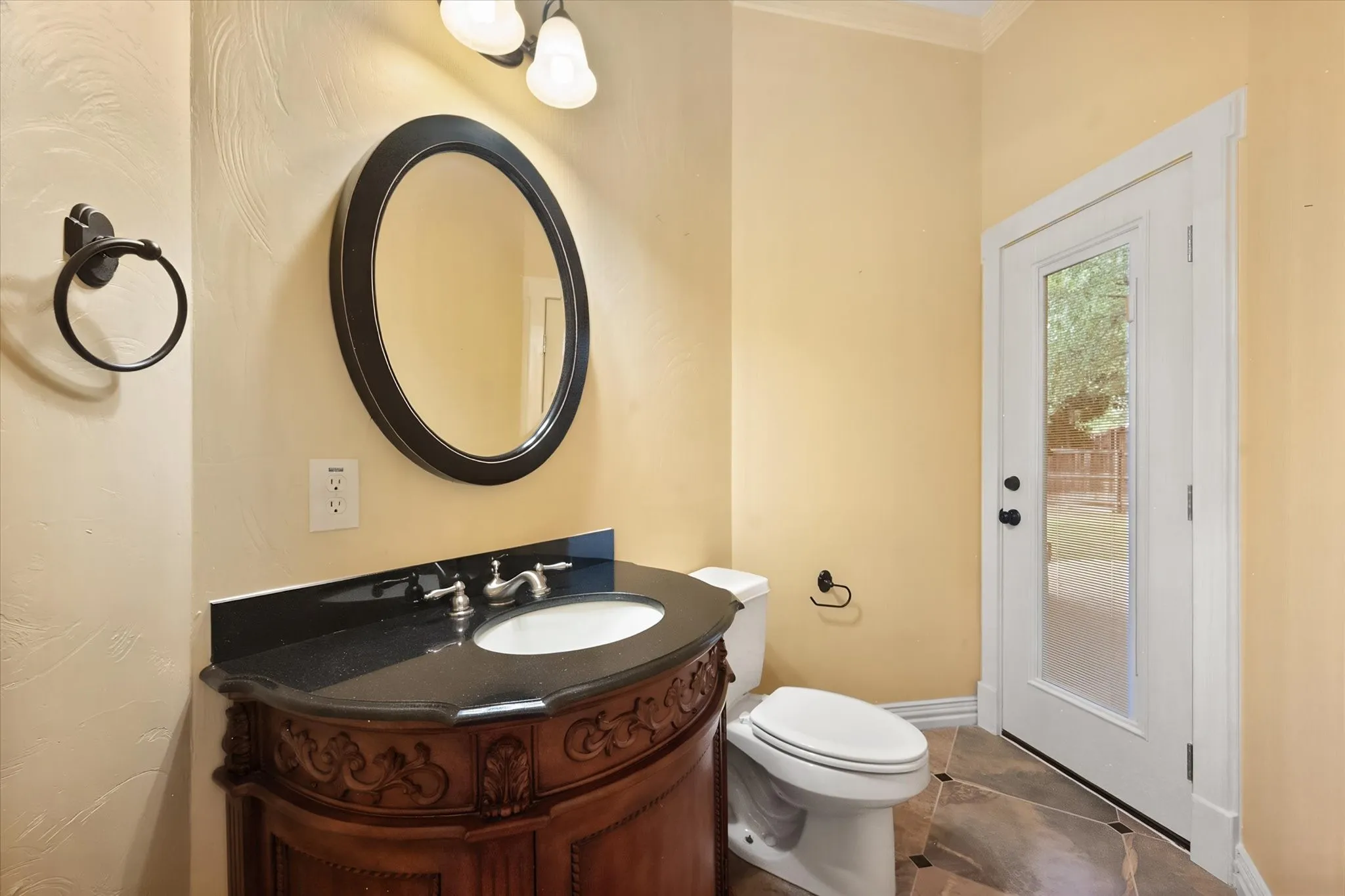 Half bath with access to backyard-perfect if you add a pool
