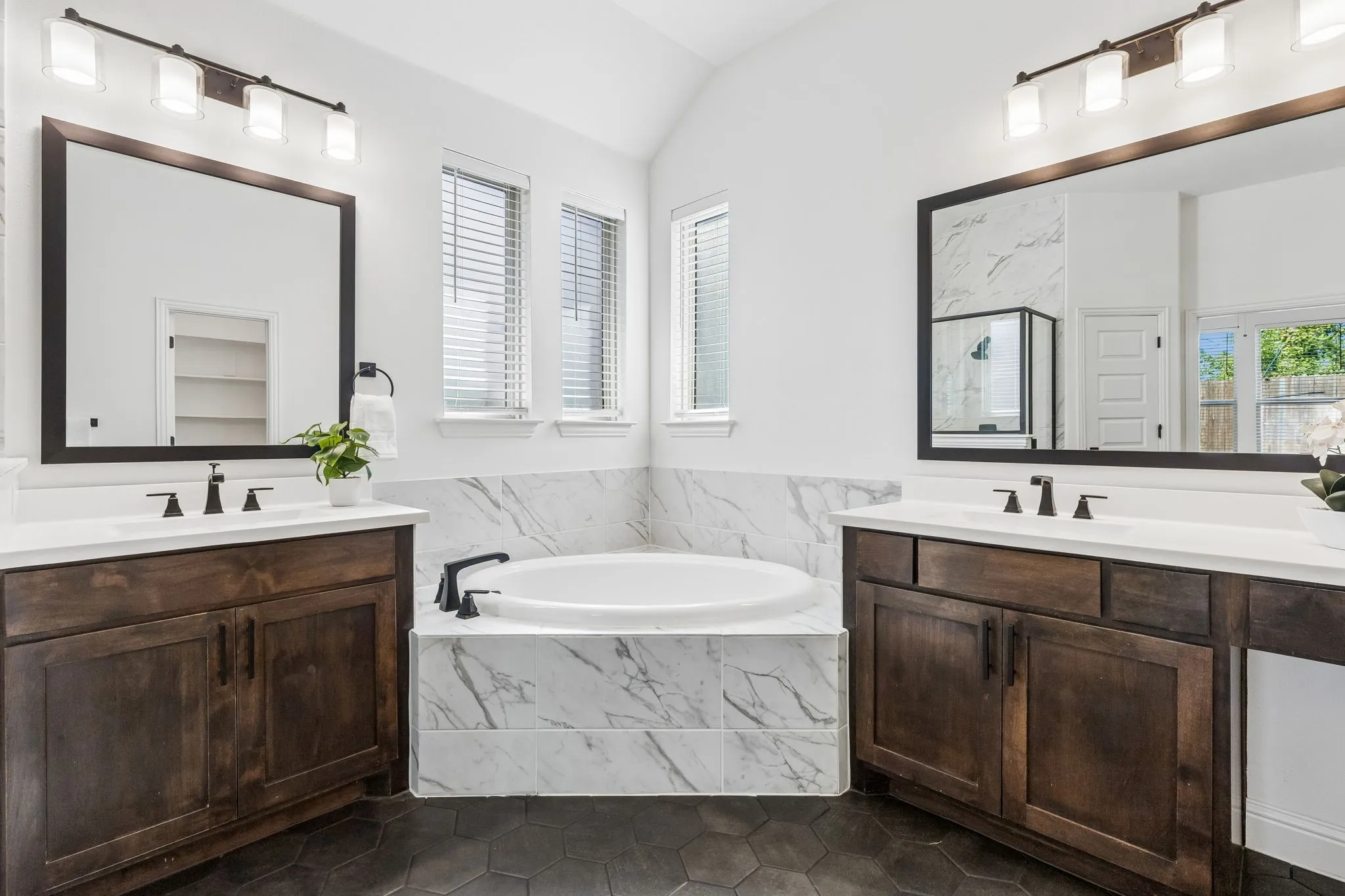Dual wood-finish vanities with white countertops