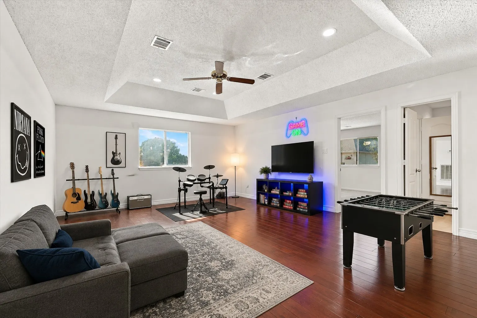 A flexible upstairs loft with wood floors, perfect for a game room, music space, hangout zone, or whatever fits your lifestyle. Virtually staged to show the possibilities.
