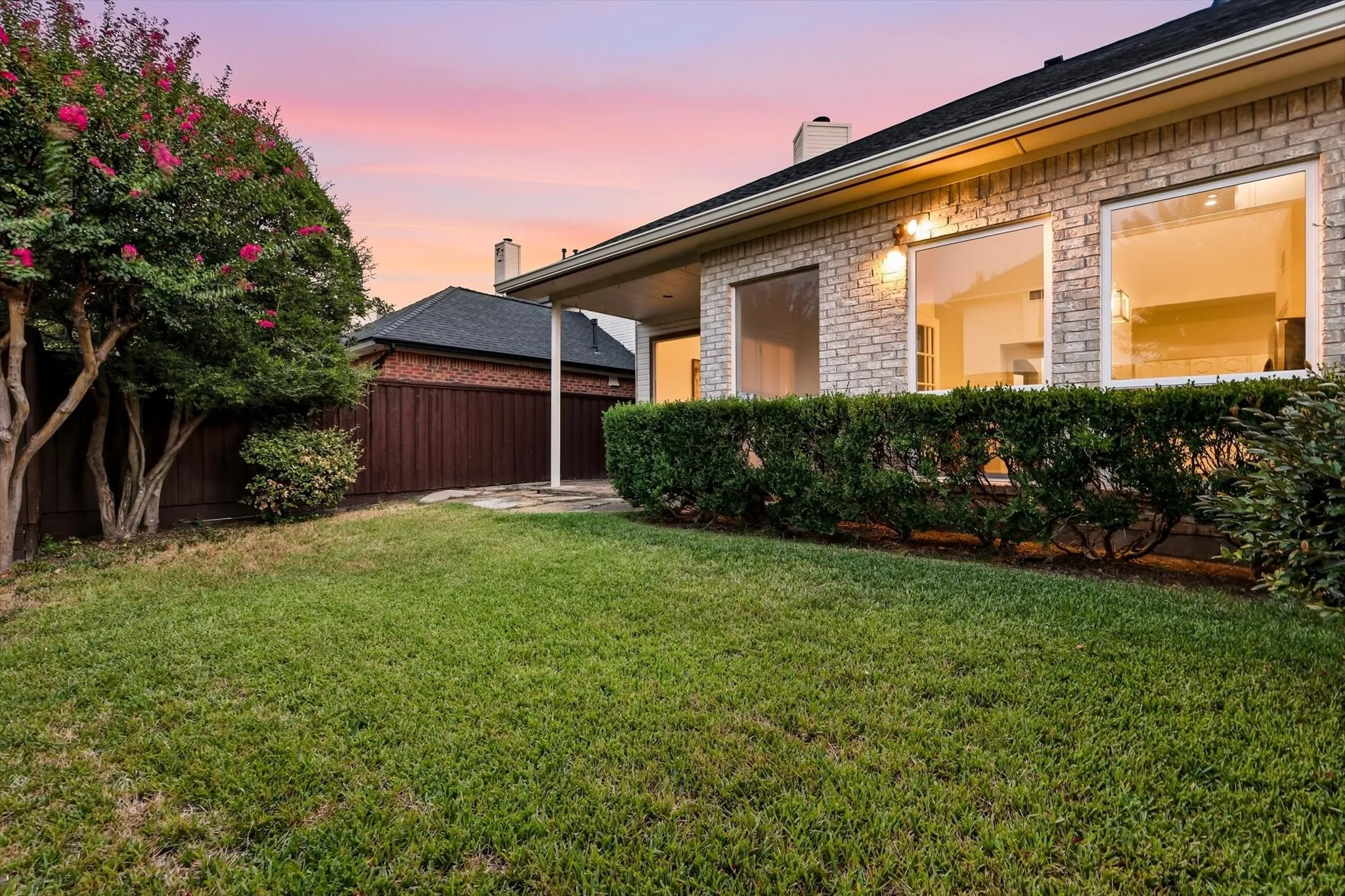 An easy-to-maintain backyard surrounded by mature landscaping, giving you a private, established feel without a lot of upkeep.