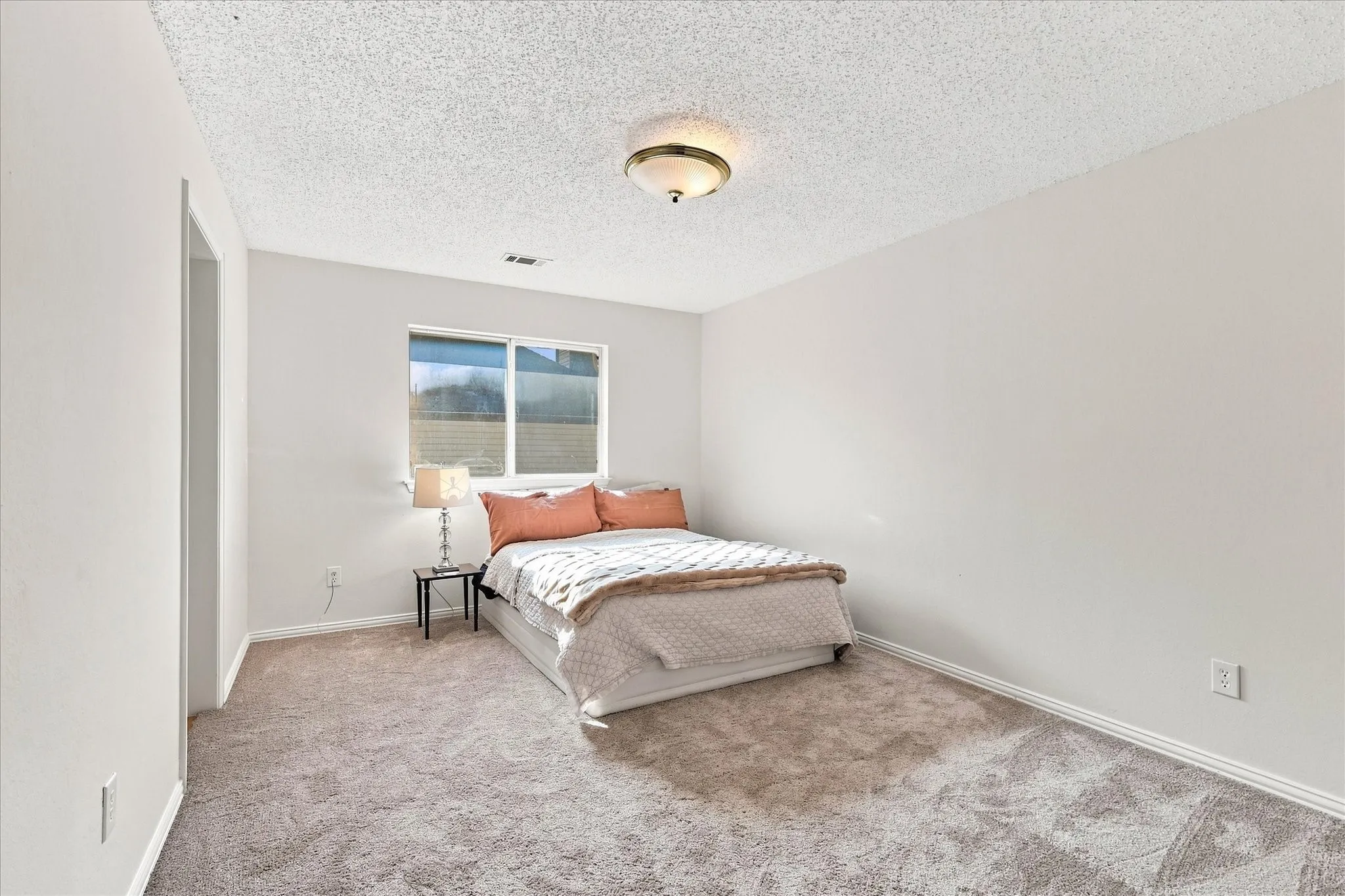 Another spacious upstairs bedroom with new carpet and a walk-in closet, giving you plenty of room for both living and storage.