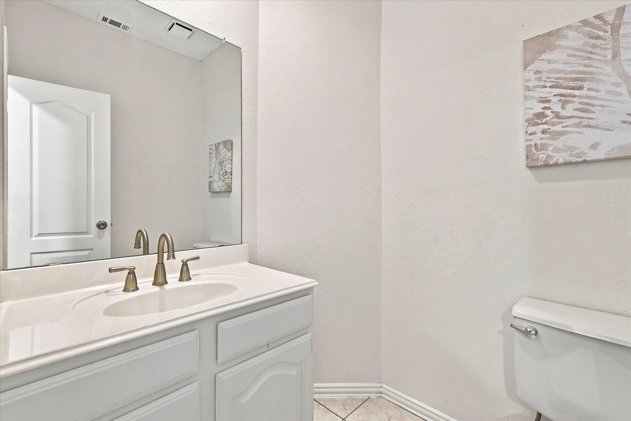 Right where you need it, yet tucked away from the main living spaces, this centrally located half bath offers convenience and privacy.