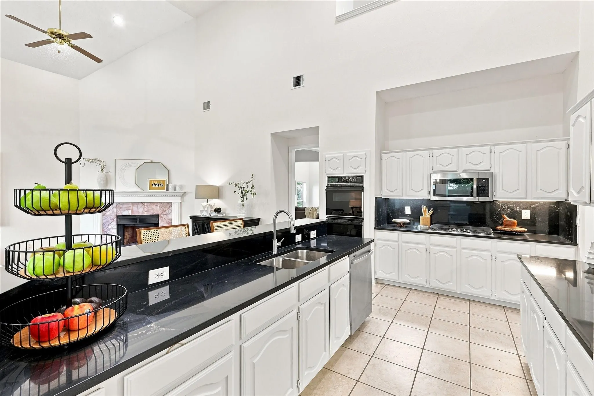 Designed for connection, the kitchen features crisp white cabinetry, sleek black granite countertops, and stainless steel appliances, all opening seamlessly to the family room. Whether you’re preparing dinner or gathering with loved ones, this inviting layout means you never have to miss a moment.