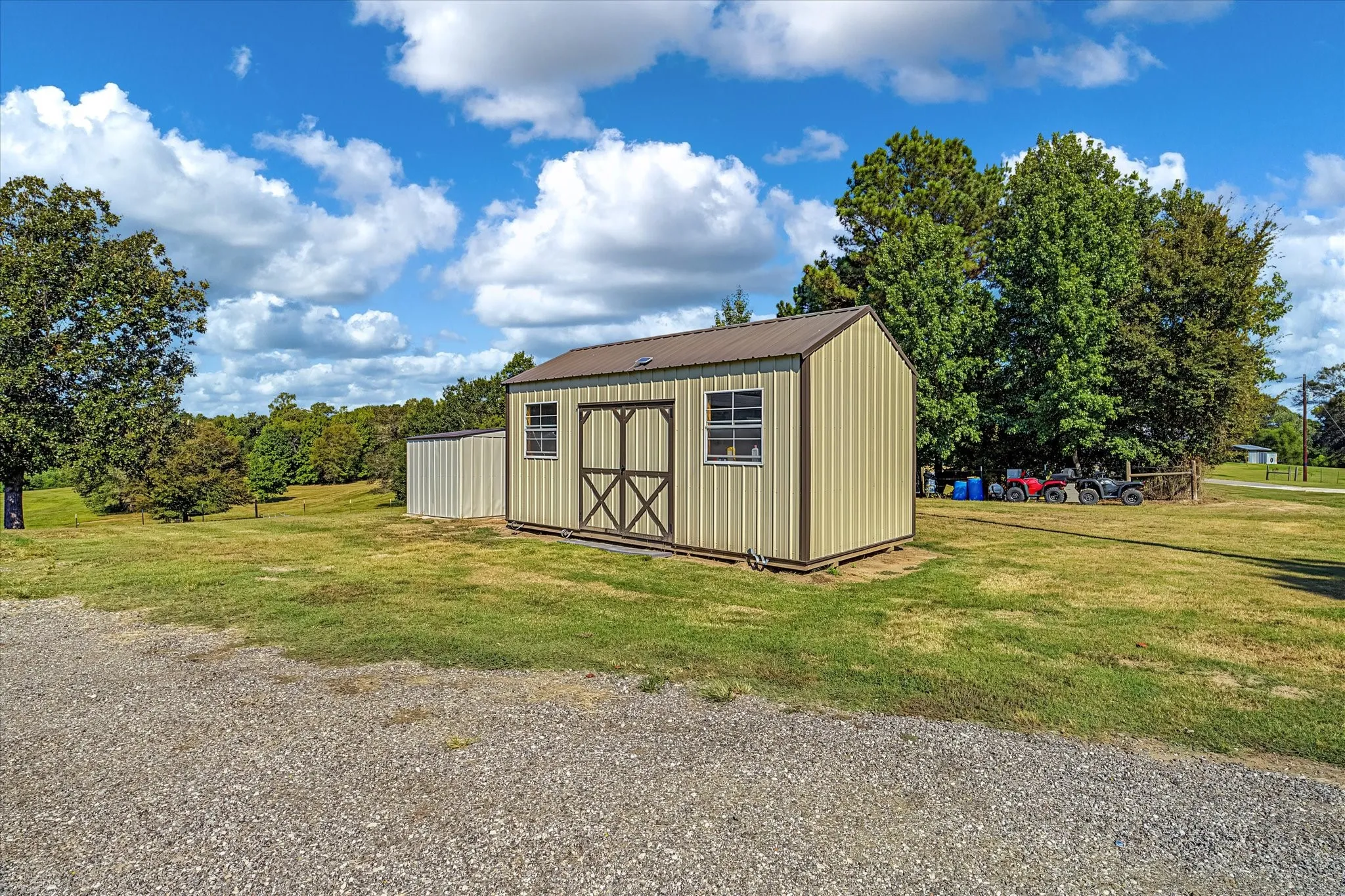10x20 framed storage building for outdoor equipment w/ covered well next to it.