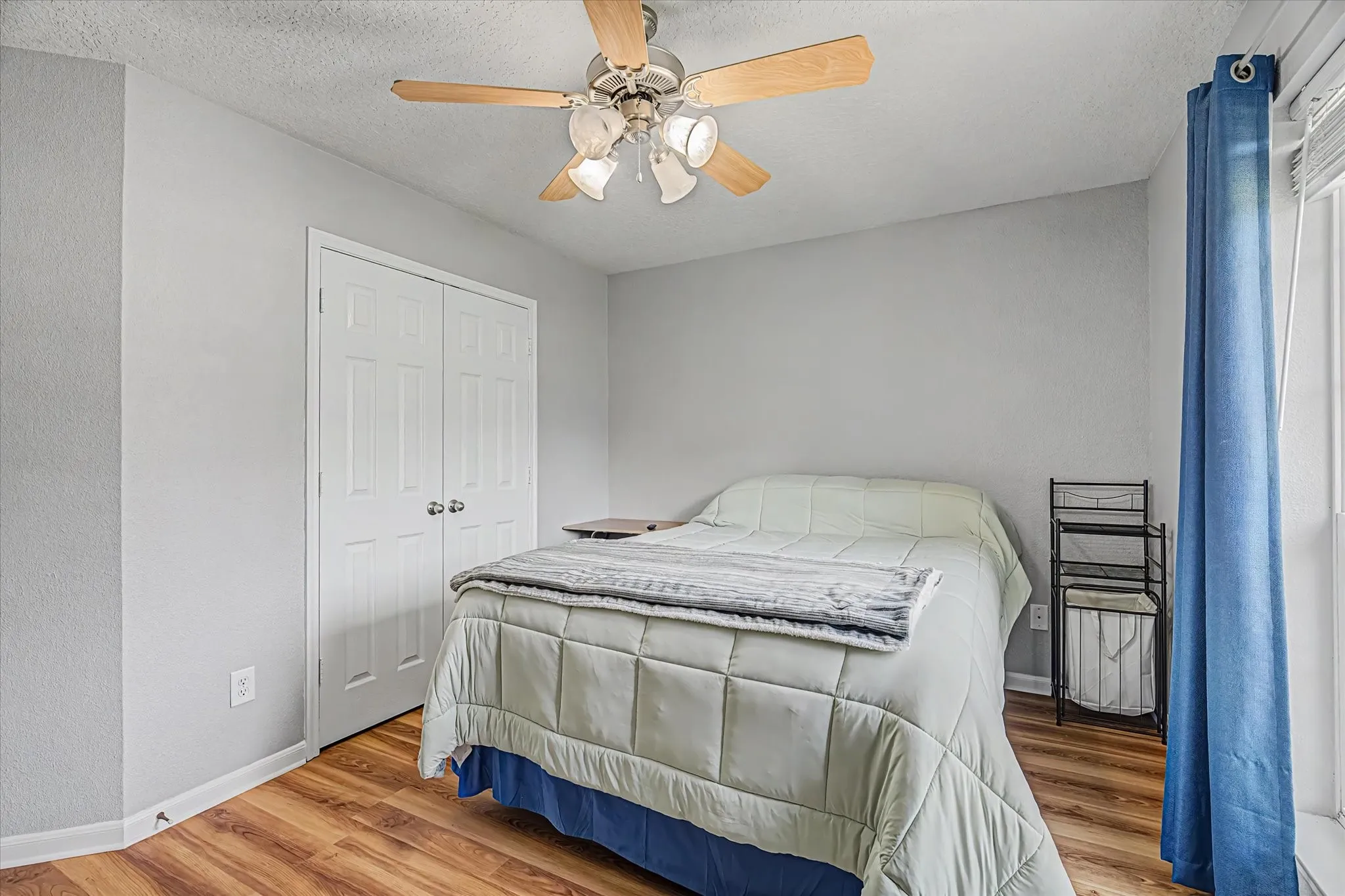 3rd bedroom w/ a ceiling fan with integrated lighting, and a window with blinds