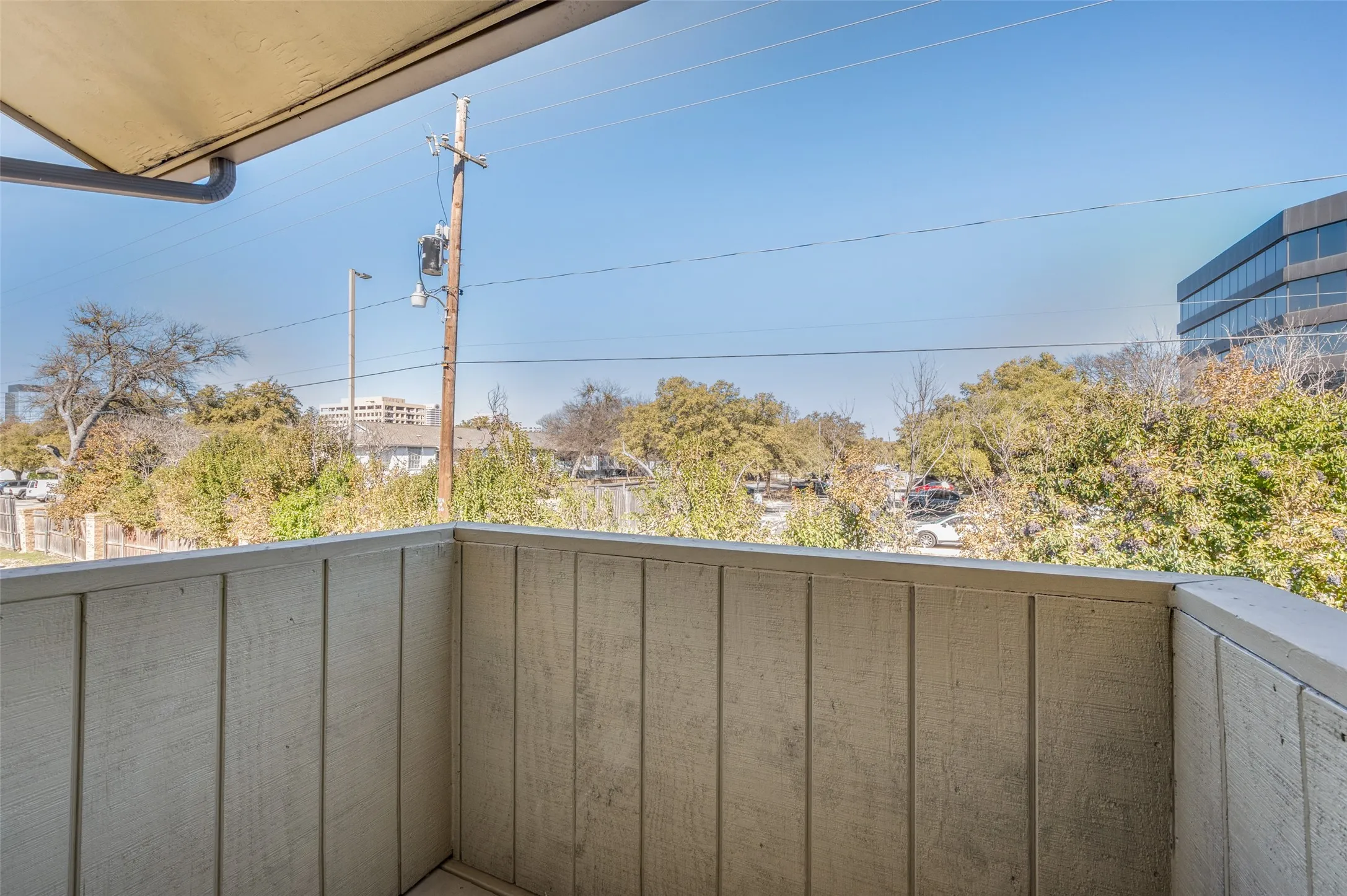 Private balcony with a wooden privacy wall and overhead awning