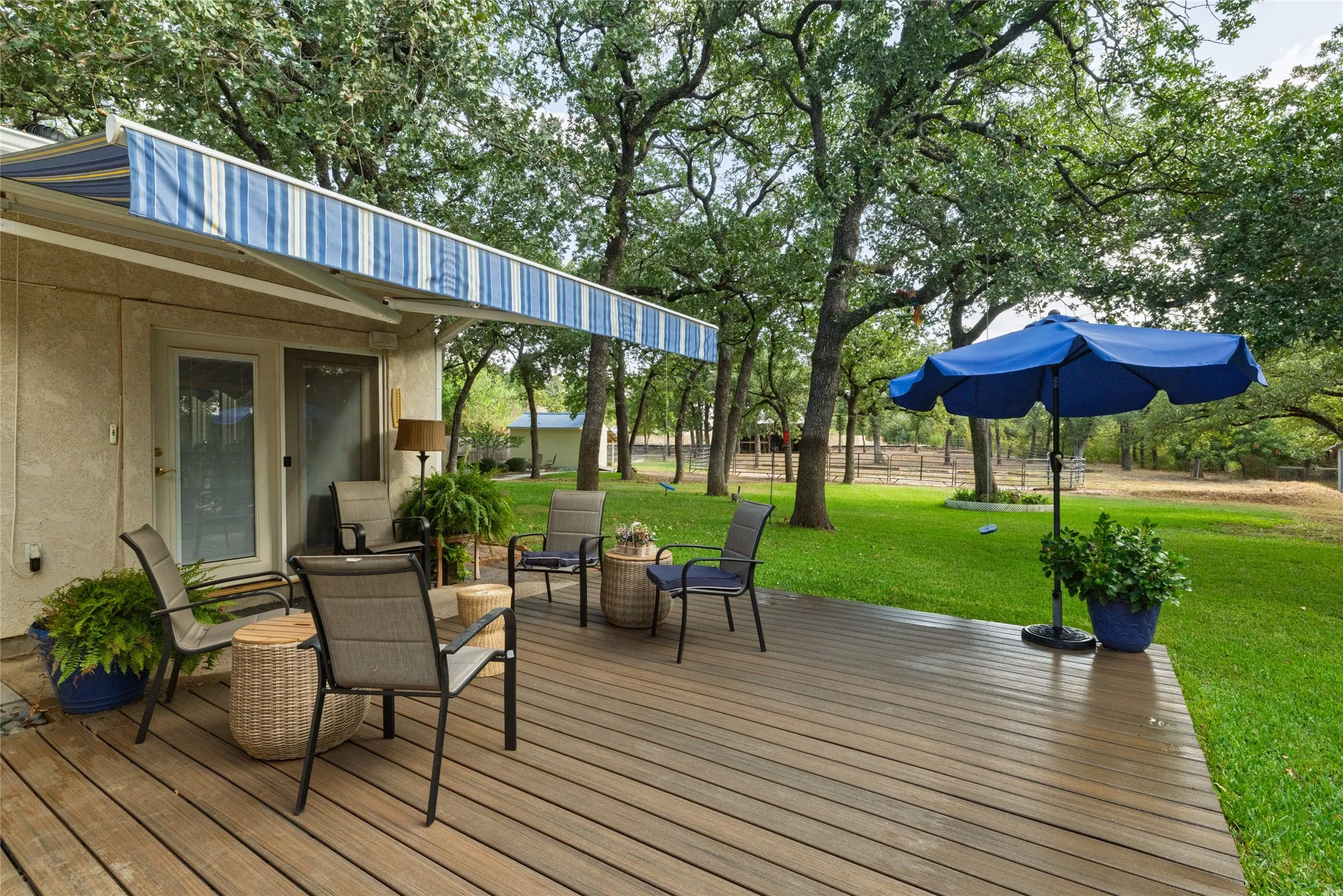 Grab a seat under the umbrella. This deck is ready for coffee or cocktails.