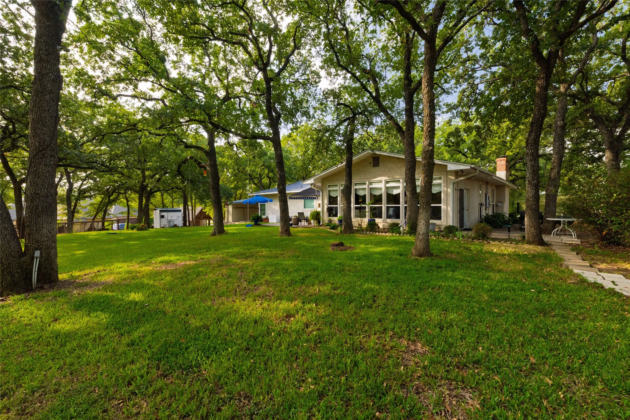 Green grass and tall trees make the perfect spot to relax outside.