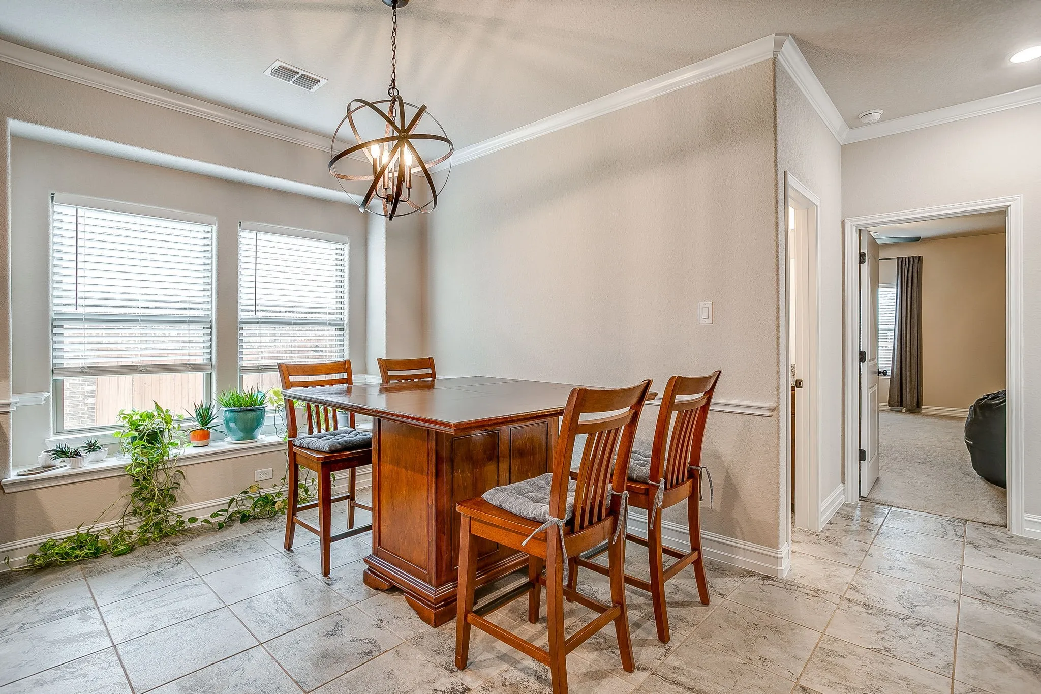 Recessed lighting, crown molding, and two windows with blinds