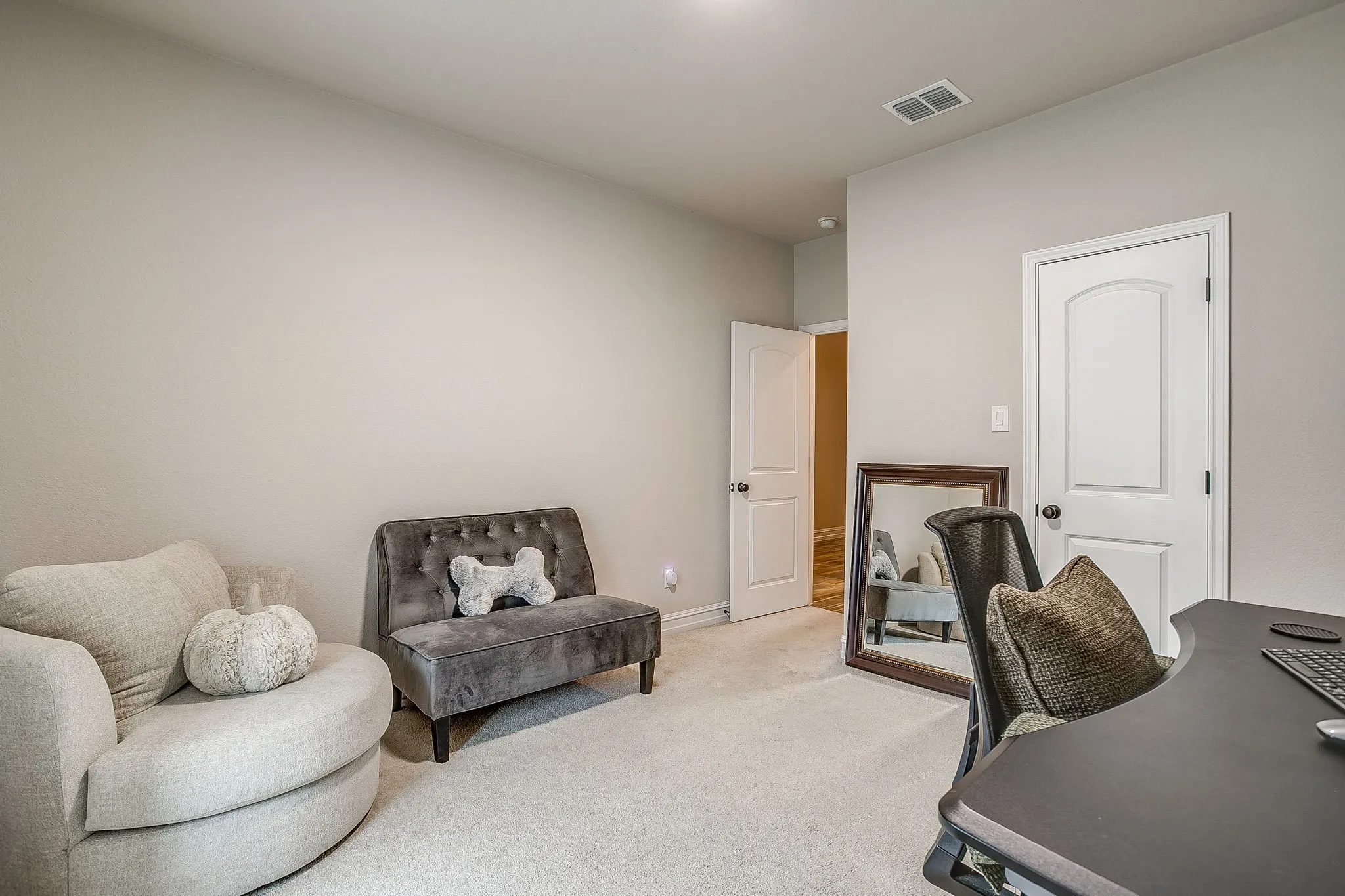 Interior room with light-colored walls and carpeted flooring