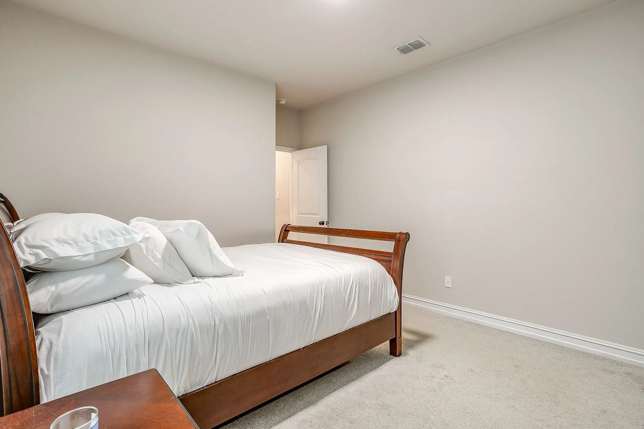 Light-toned wall paint, white trim, and light-colored carpeting throughout