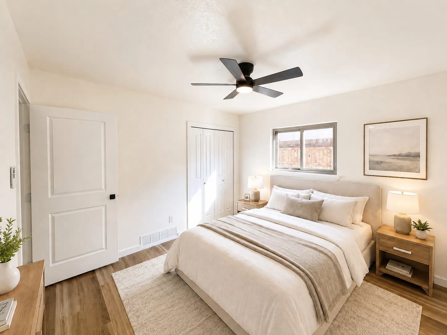 Wood-finish flooring with light-toned walls, a modern ceiling fan, and a window with a solid frame