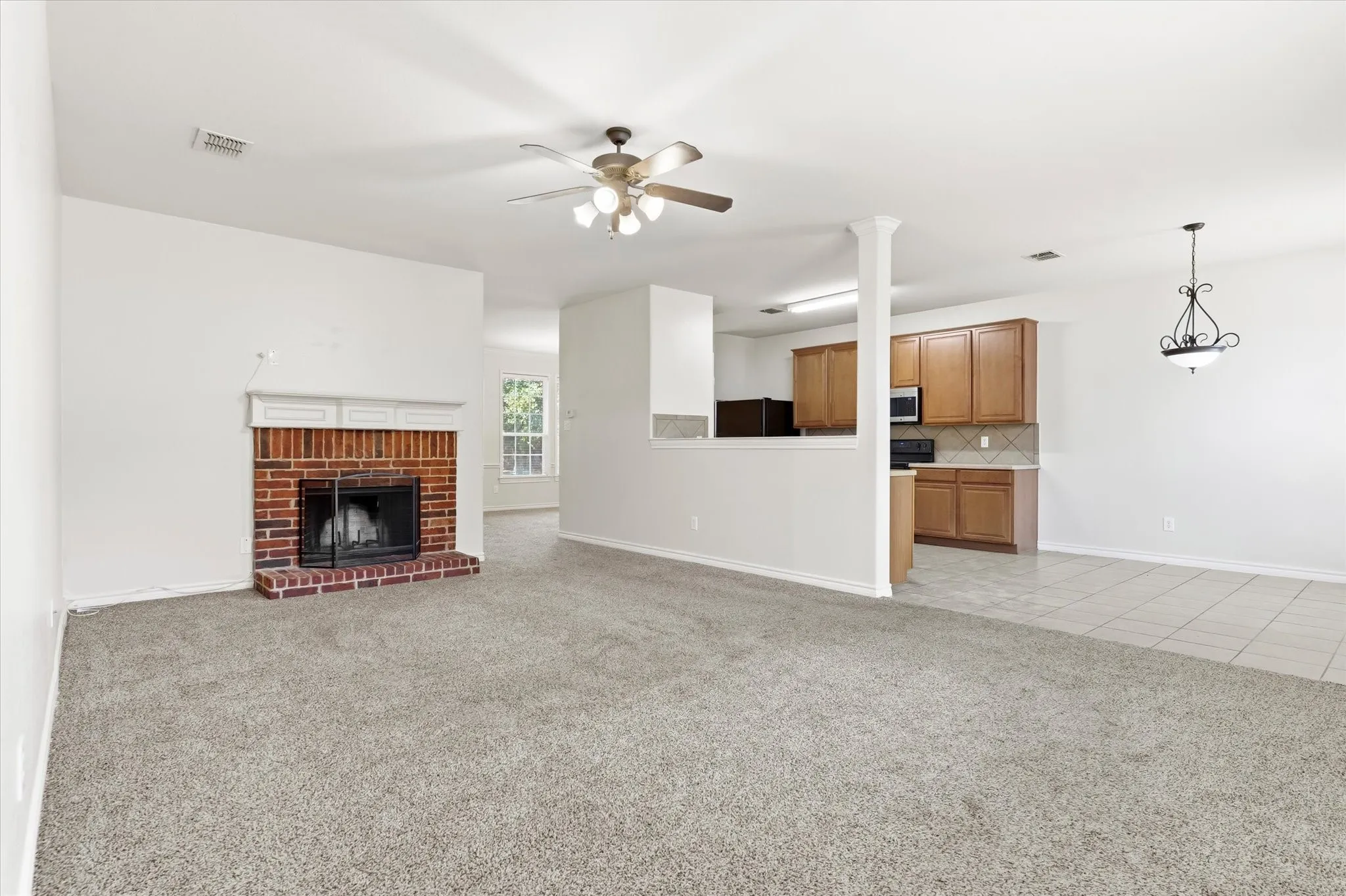 Brick fireplace with white mantel and hearth