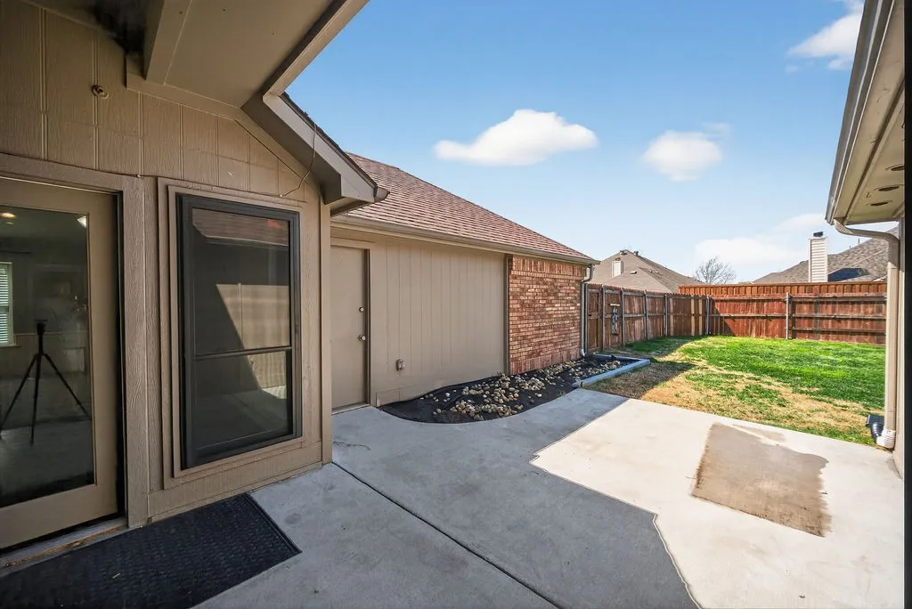 Fenced backyard with a patio area