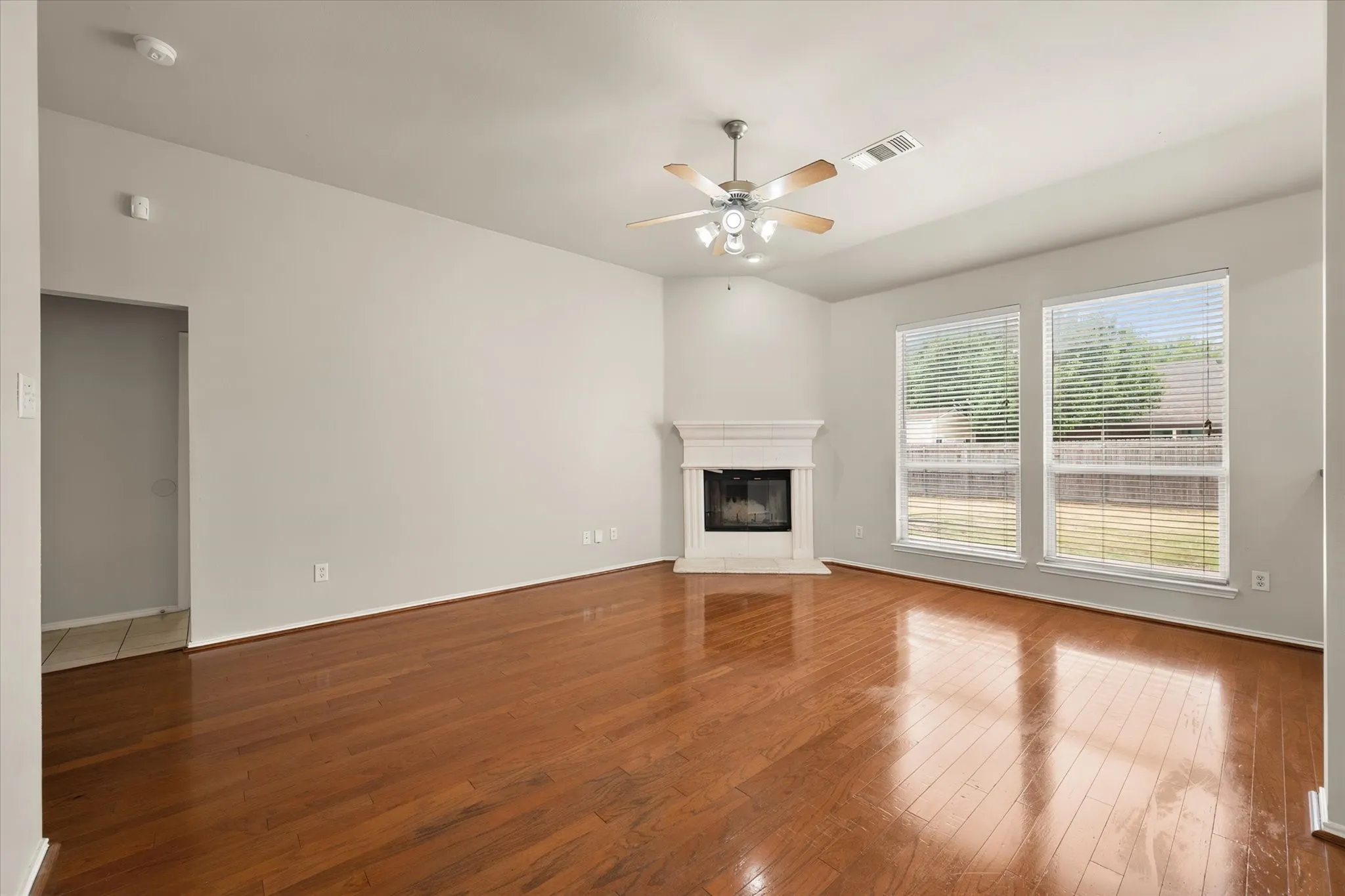 Huge living room with wood burning fireplace and wood floors