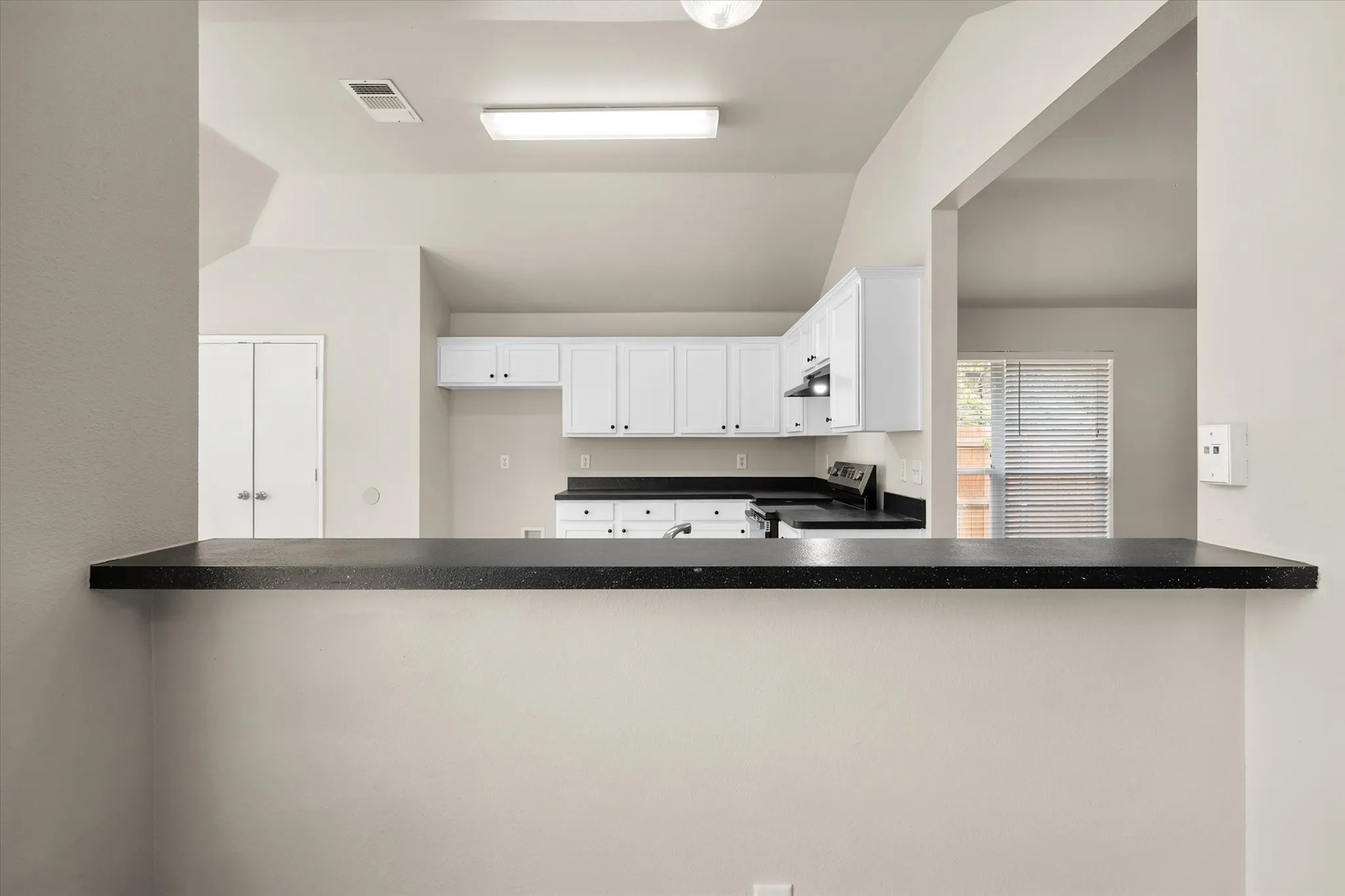 Breakfast bar between kitchen and living room