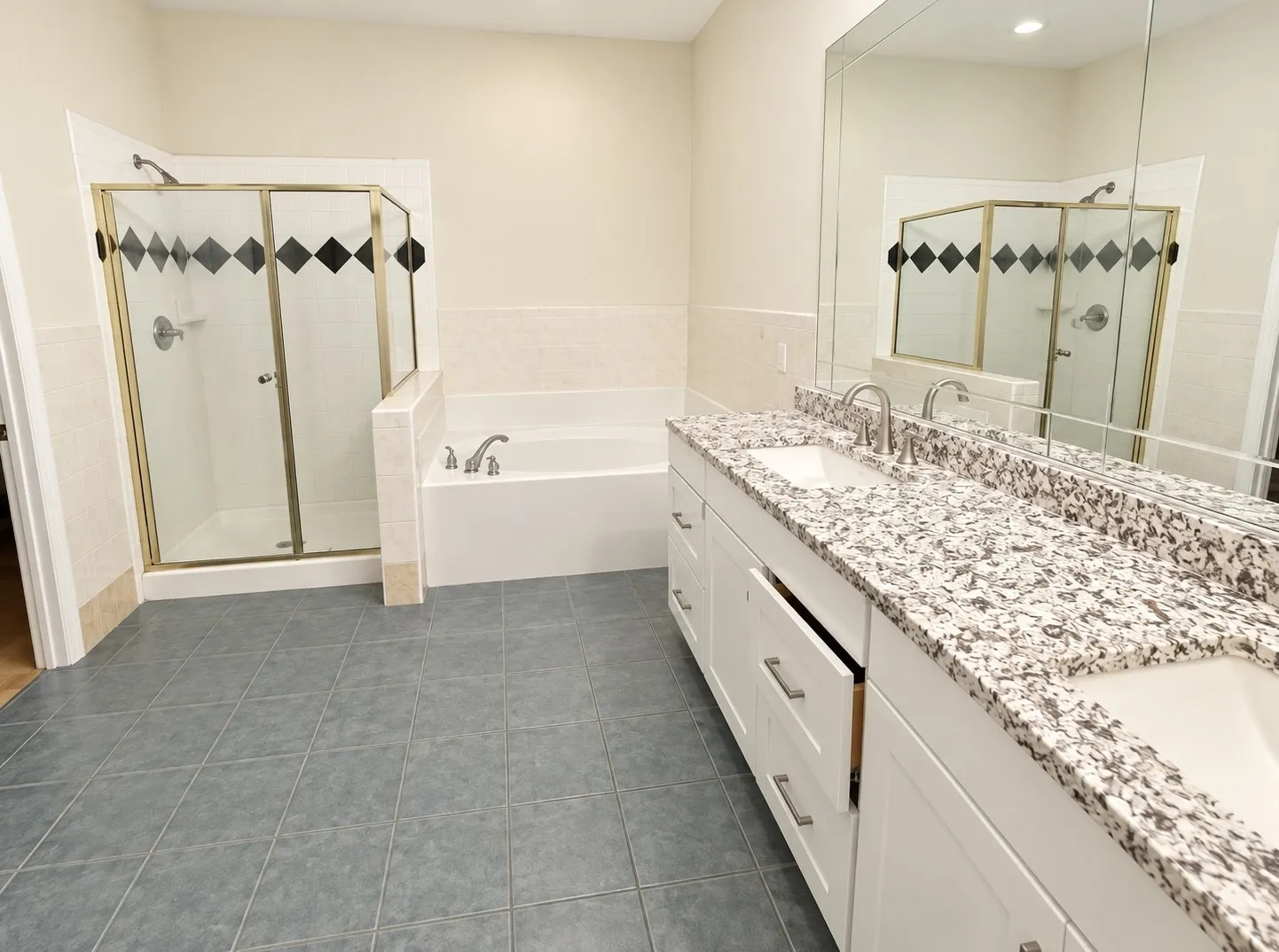 Dual vanity with integrated sinks, granite-style countertop, and polished chrome fixtures