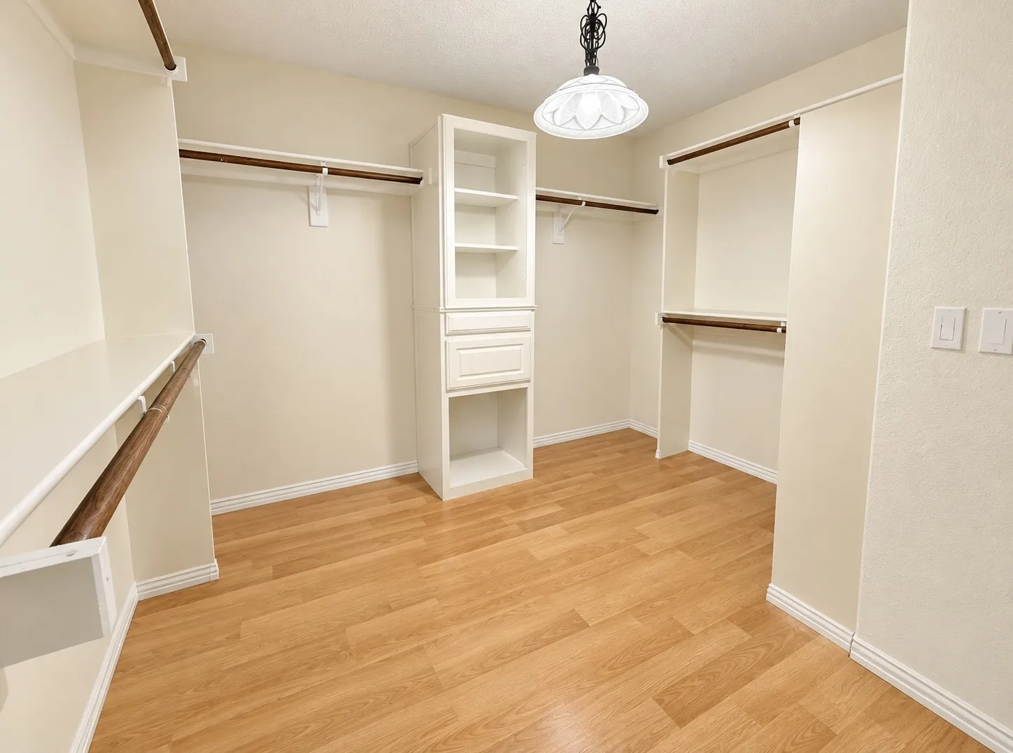Wood-finish flooring with white baseboards
