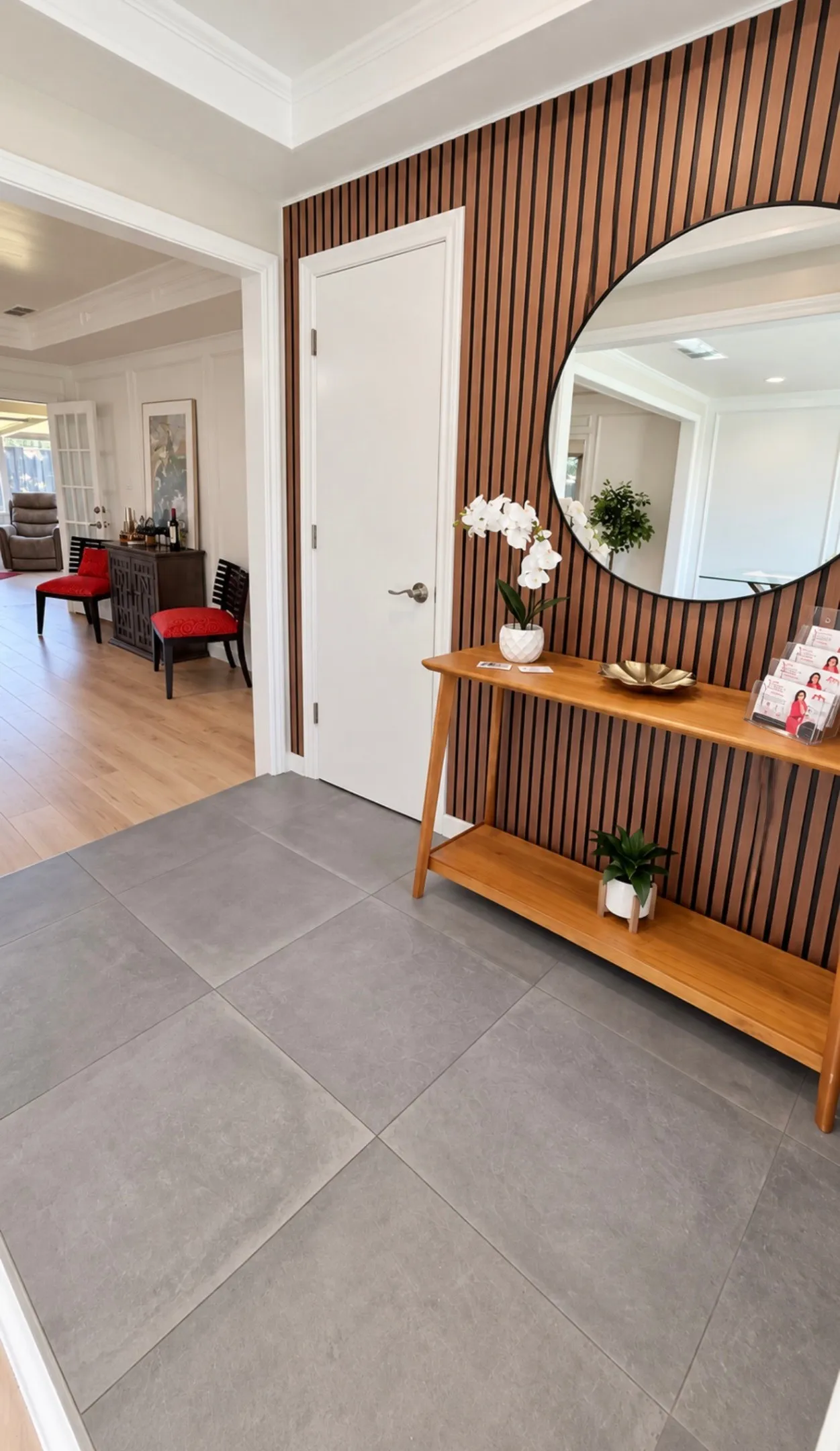 Large format gray floor tiles and wood-finish wall paneling