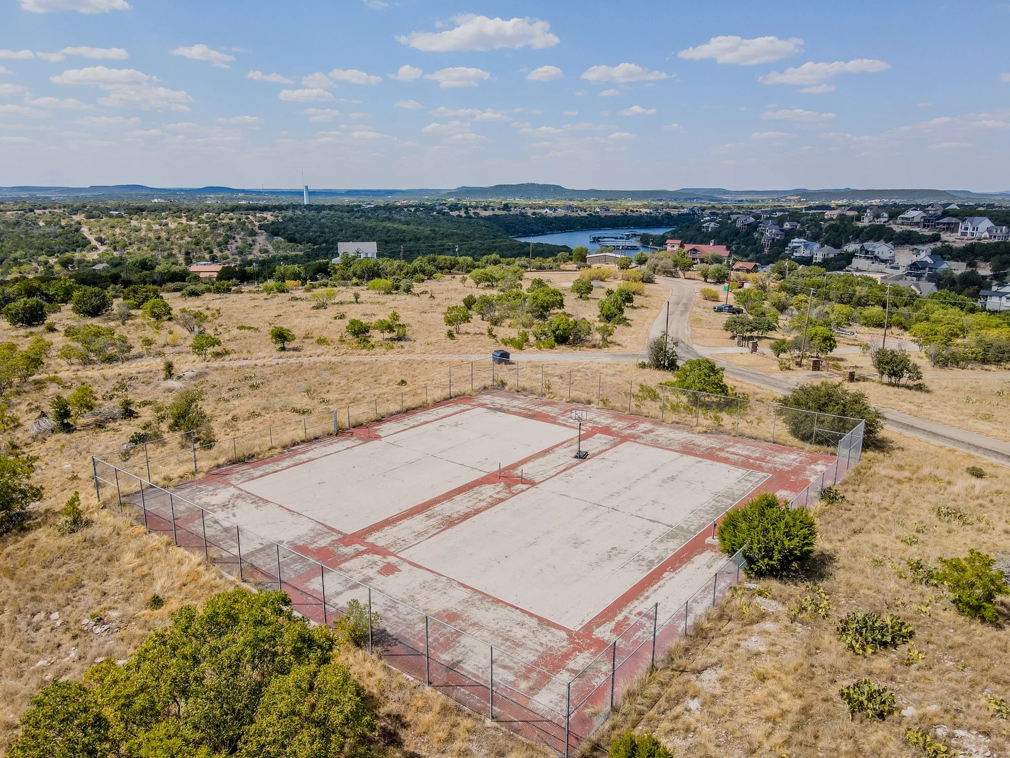 Neeleys Slough tennis court and community dumpster
