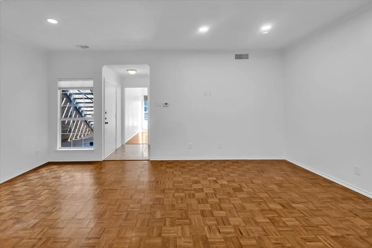 Living room with view of front door and hallway to bath and bedroom