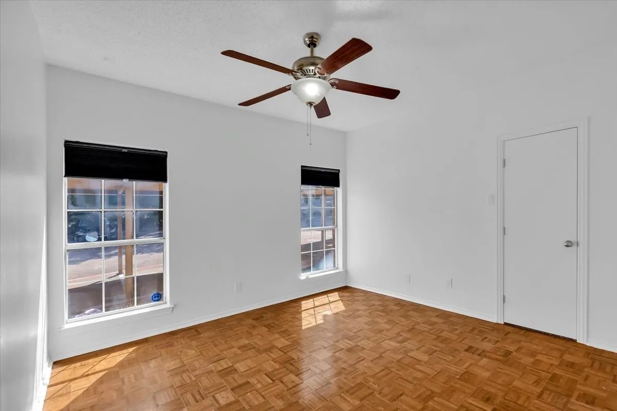 Primary bedroom with parquet wood floors