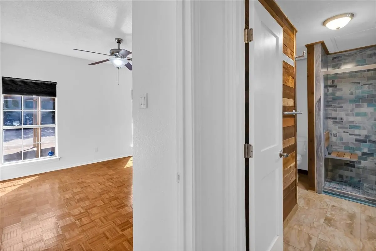 View of primary bedroom and bathroom