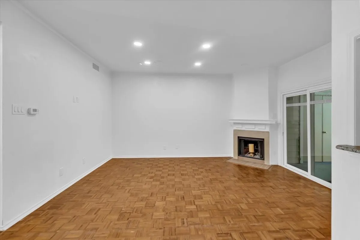 Living room with view of fireplace and pation