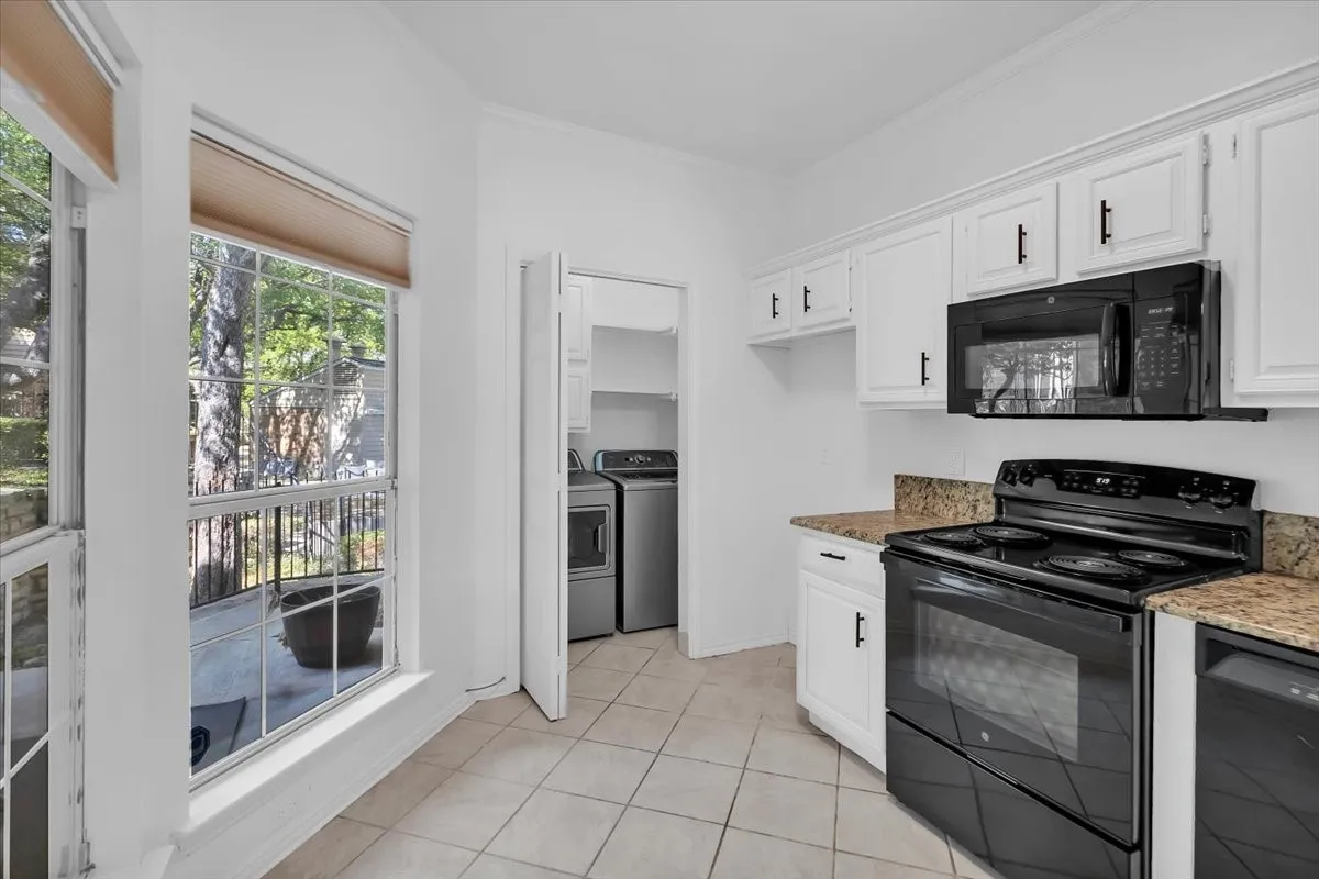 Kitchen with view of laundry—new refrigerator will be installed prior to move in