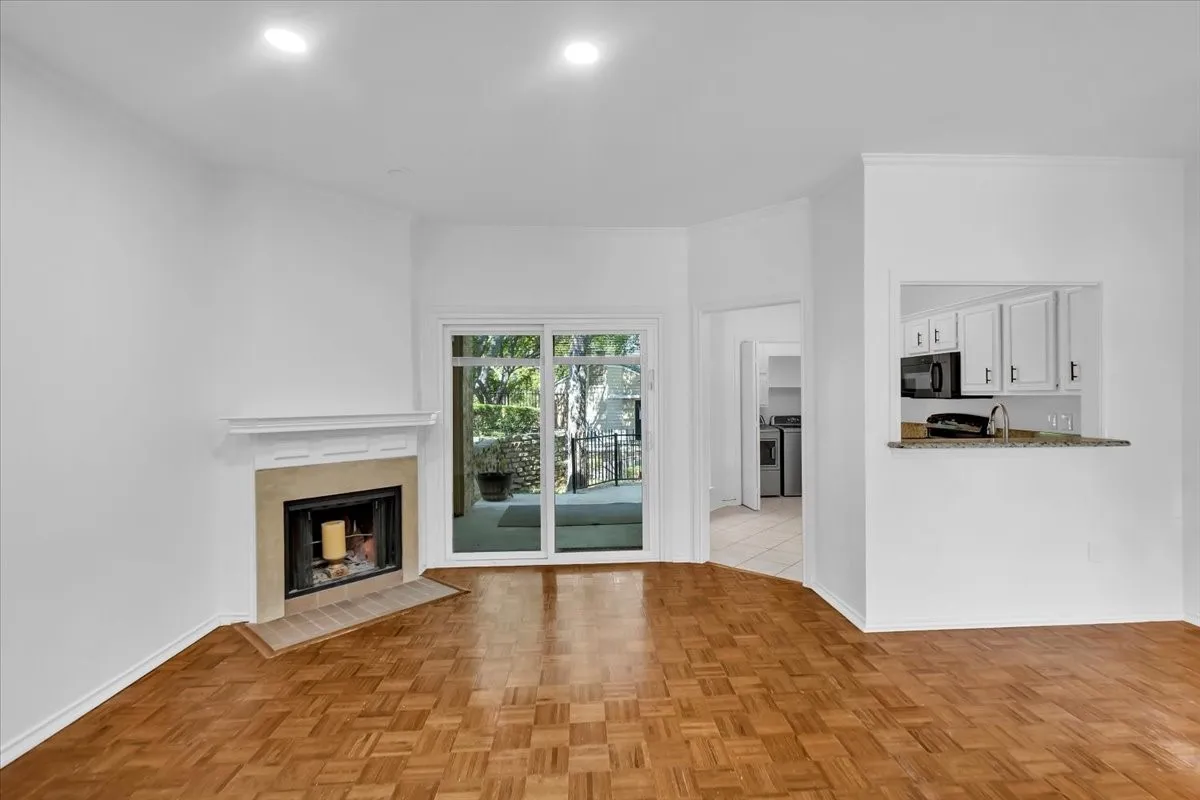Living room with view of kitchen and walk out patio
